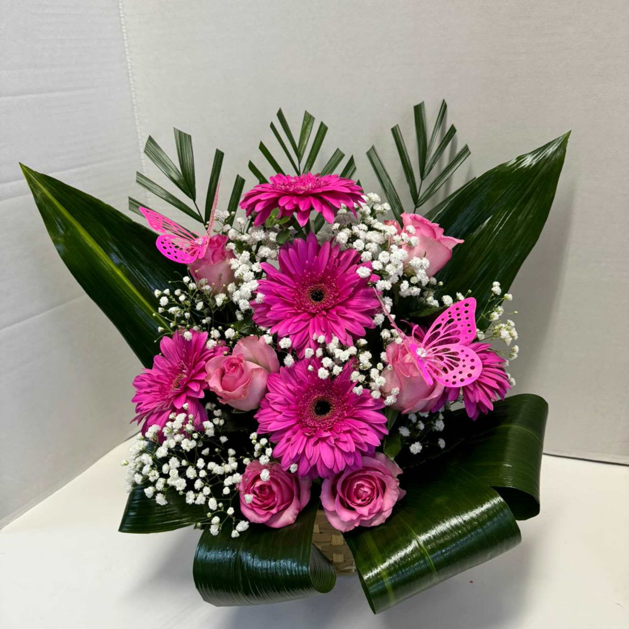 We designed the pink arrangement with roses and gerberas, taking care of