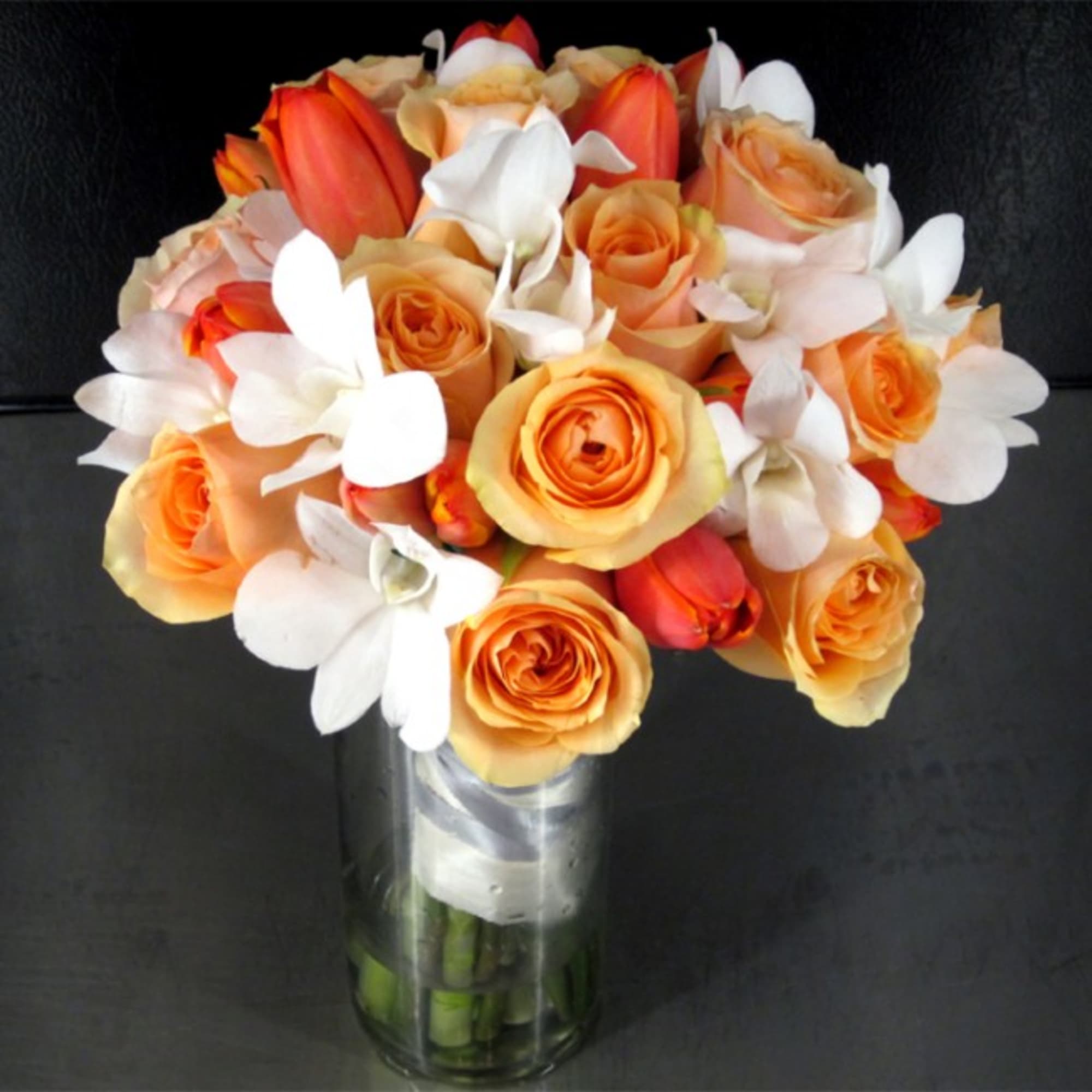 This Bridal Bouquet features Ecuadorian Roses, Holland Tulips and Dendrobium Orchids. All