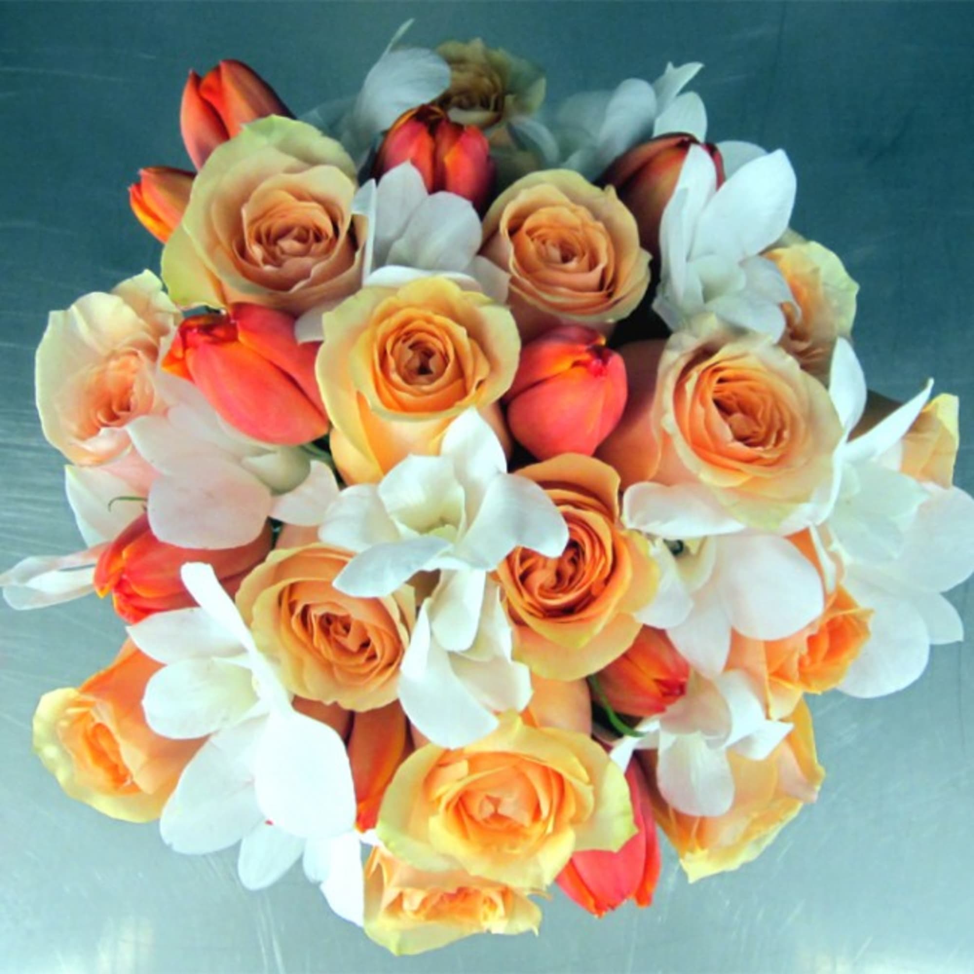 This Bridal Bouquet features Ecuadorian Roses, Holland Tulips and Dendrobium Orchids. All