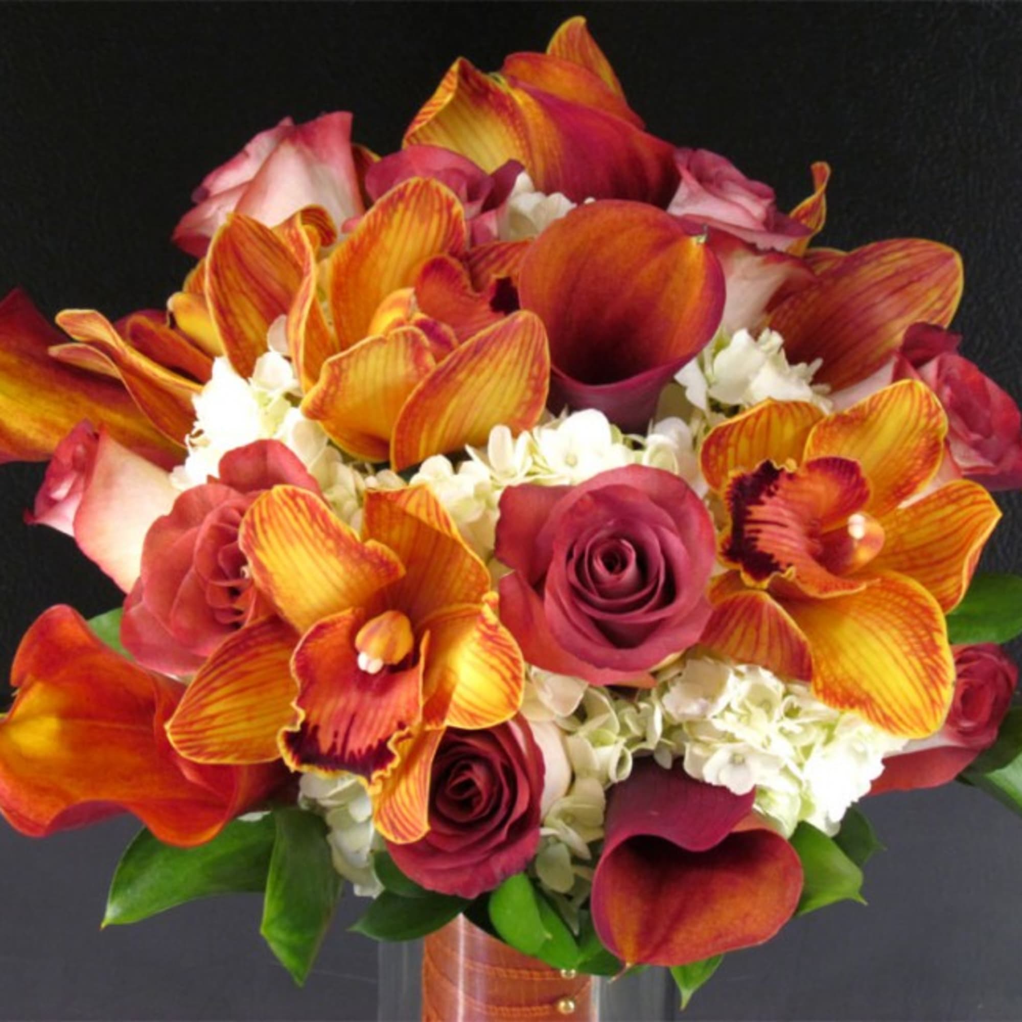 This premium bridal bouquet features flame mini calla lilies, rustic orange cymbidium