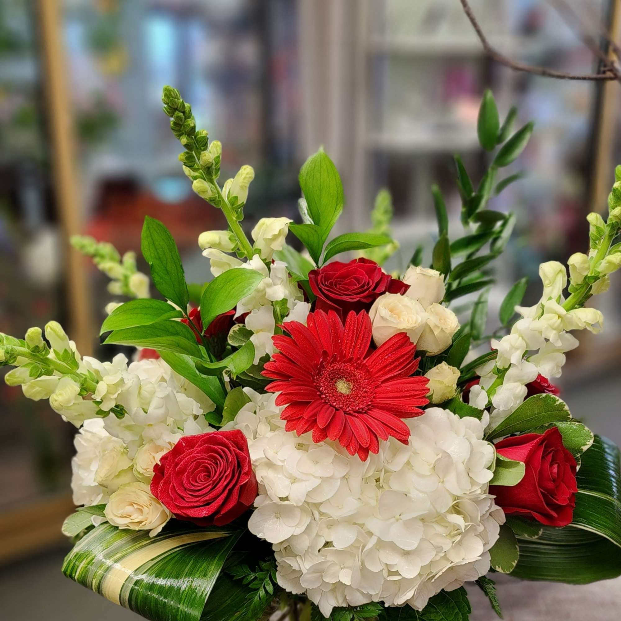 A beautiful mix of hydrangeas, gerbera daisy, snap dragons, roses, spray roses