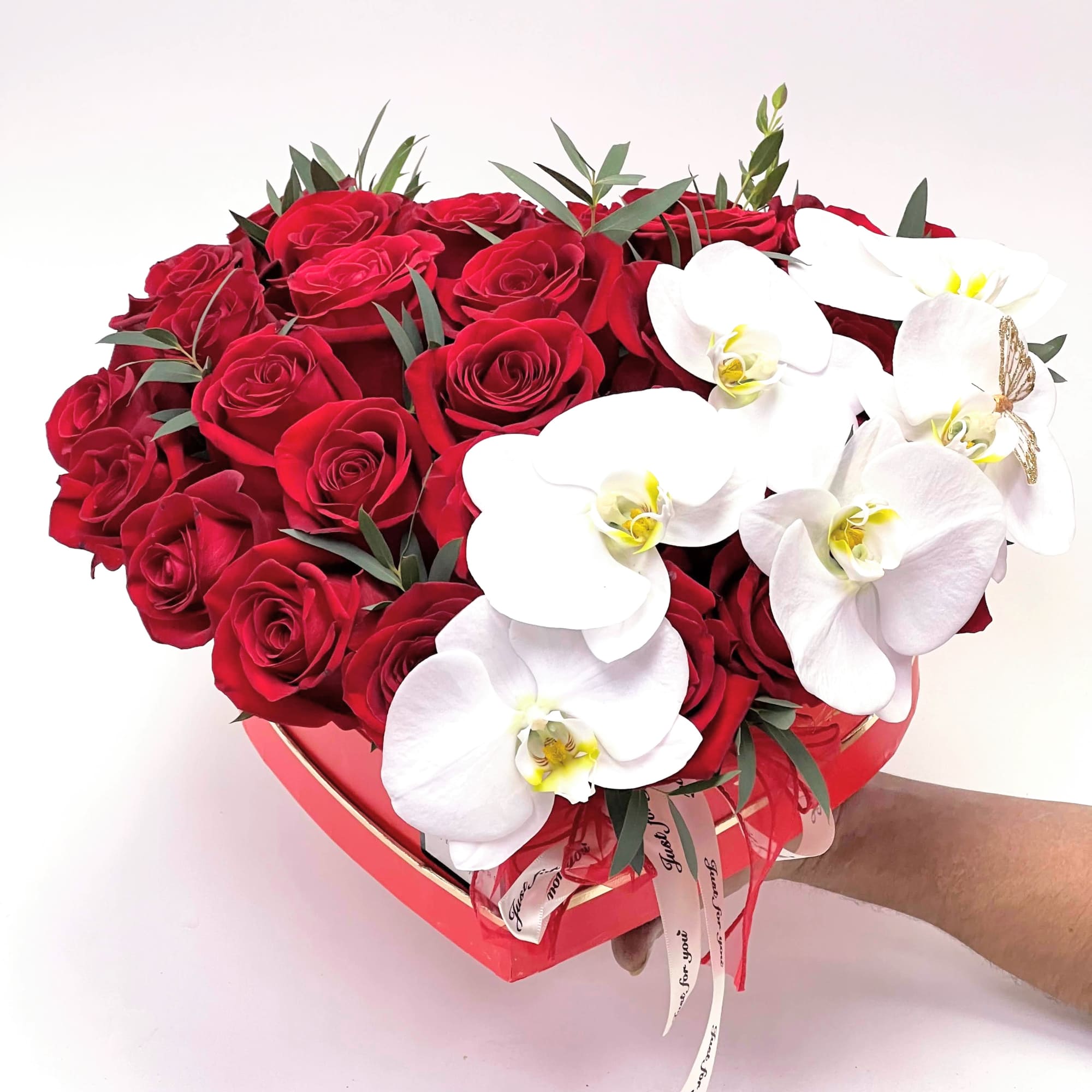 25 red roses with white Phelaenopsis Orchids