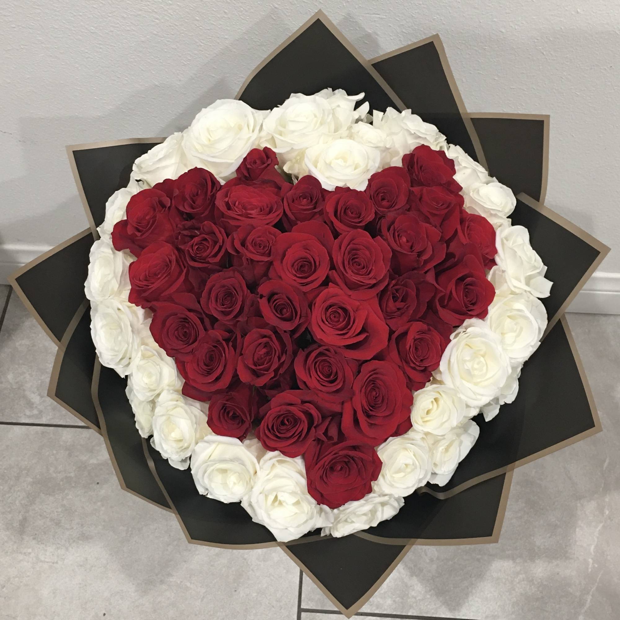 Red Heart roses surrounded by white roses a total of 75 roses