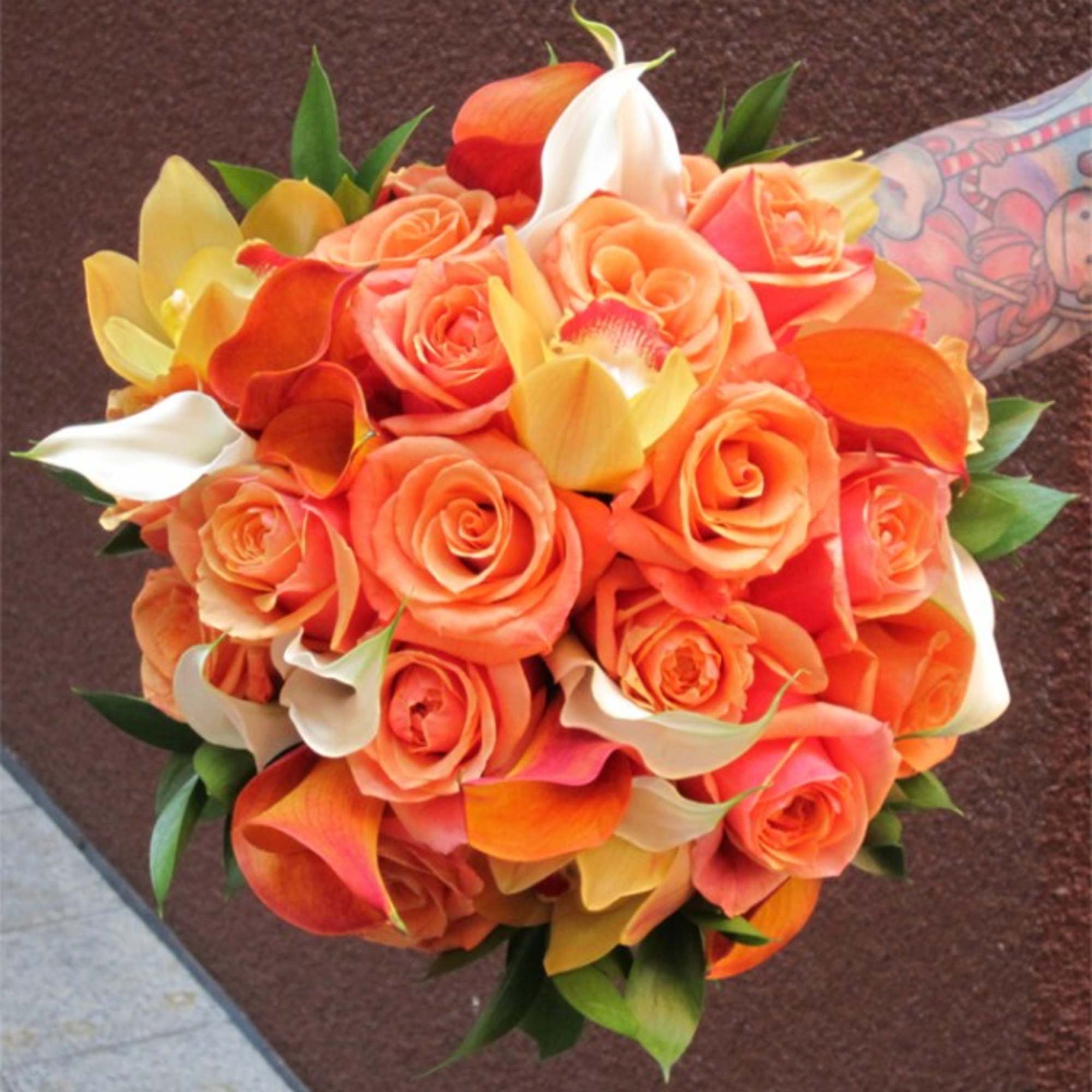 Bridal bouquet featuring Ecuadorian Roses, Mini Calla Lilies and Cymbidium Orchids. All