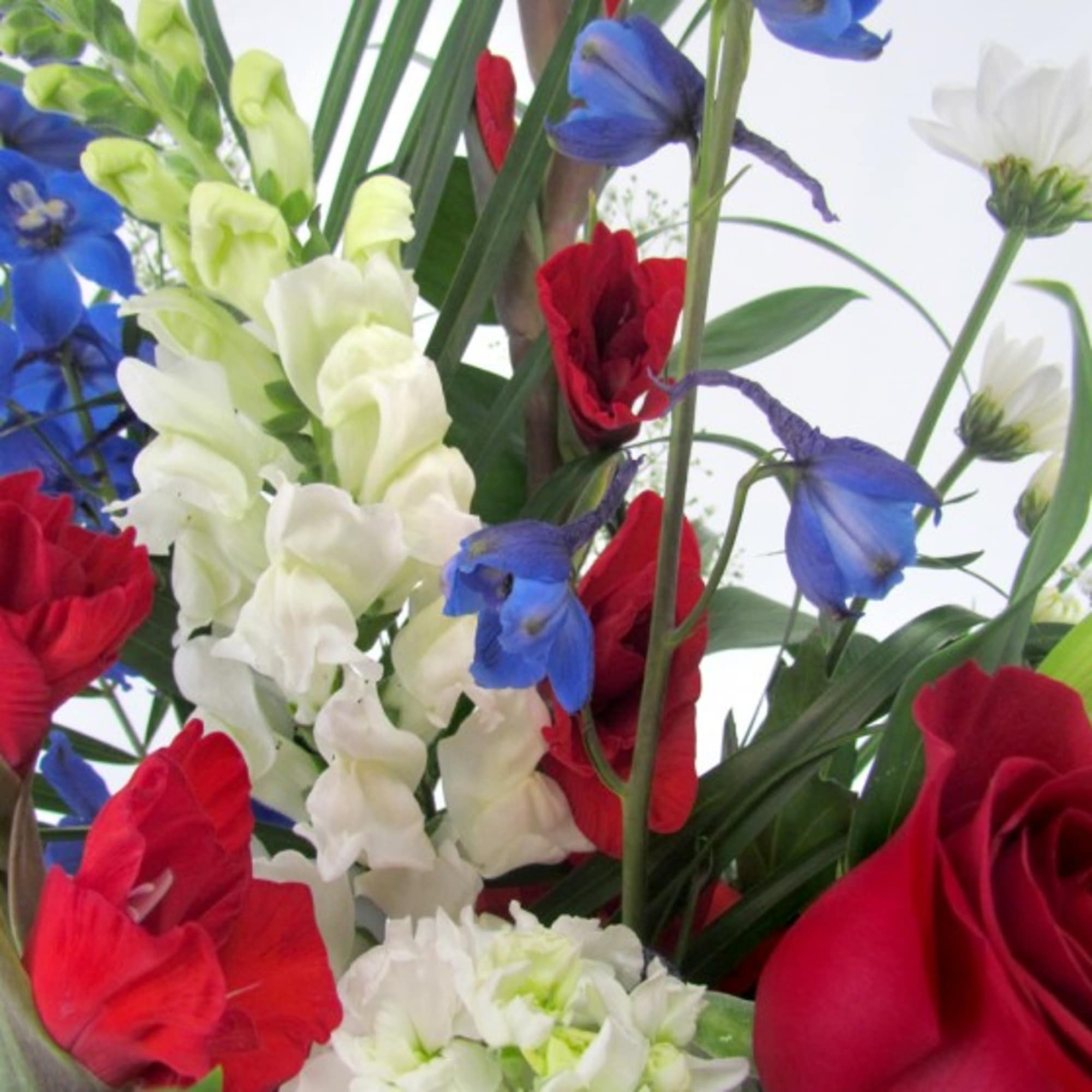 A beautiful and meaningful symbol of love and remembrance, this patriotic spray