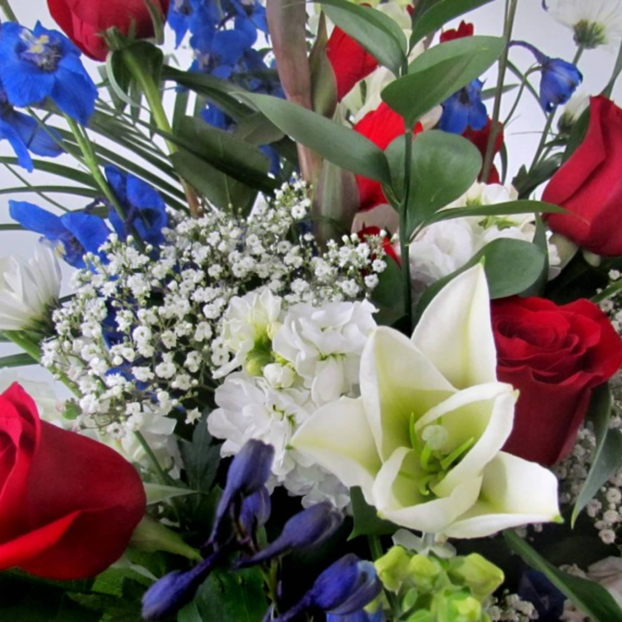 A beautiful and meaningful symbol of love and remembrance, this patriotic spray
