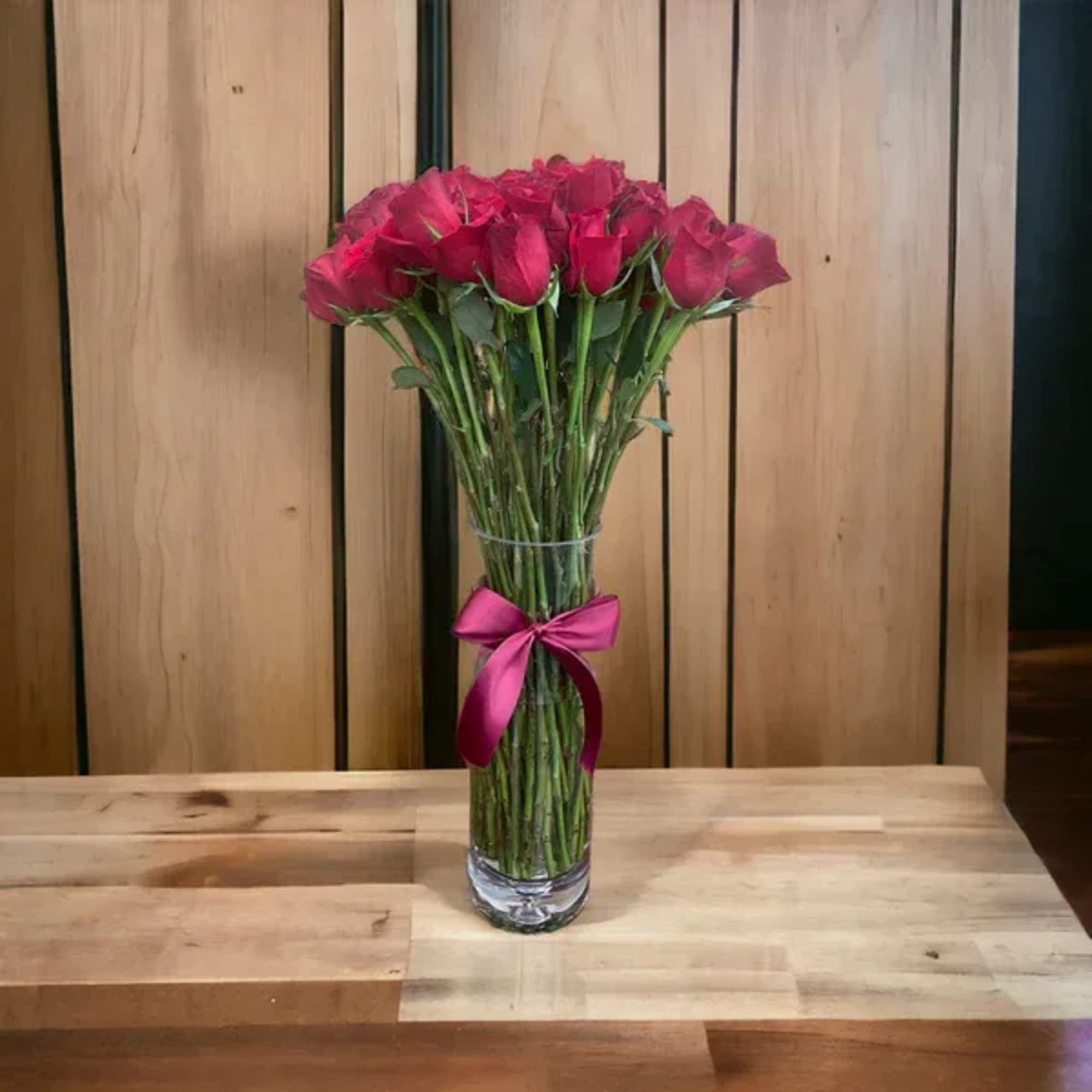 50 stems of red roses in a clear large illusion vase. Picked 50 stems of red roses in a clear large illusion vase. Picked