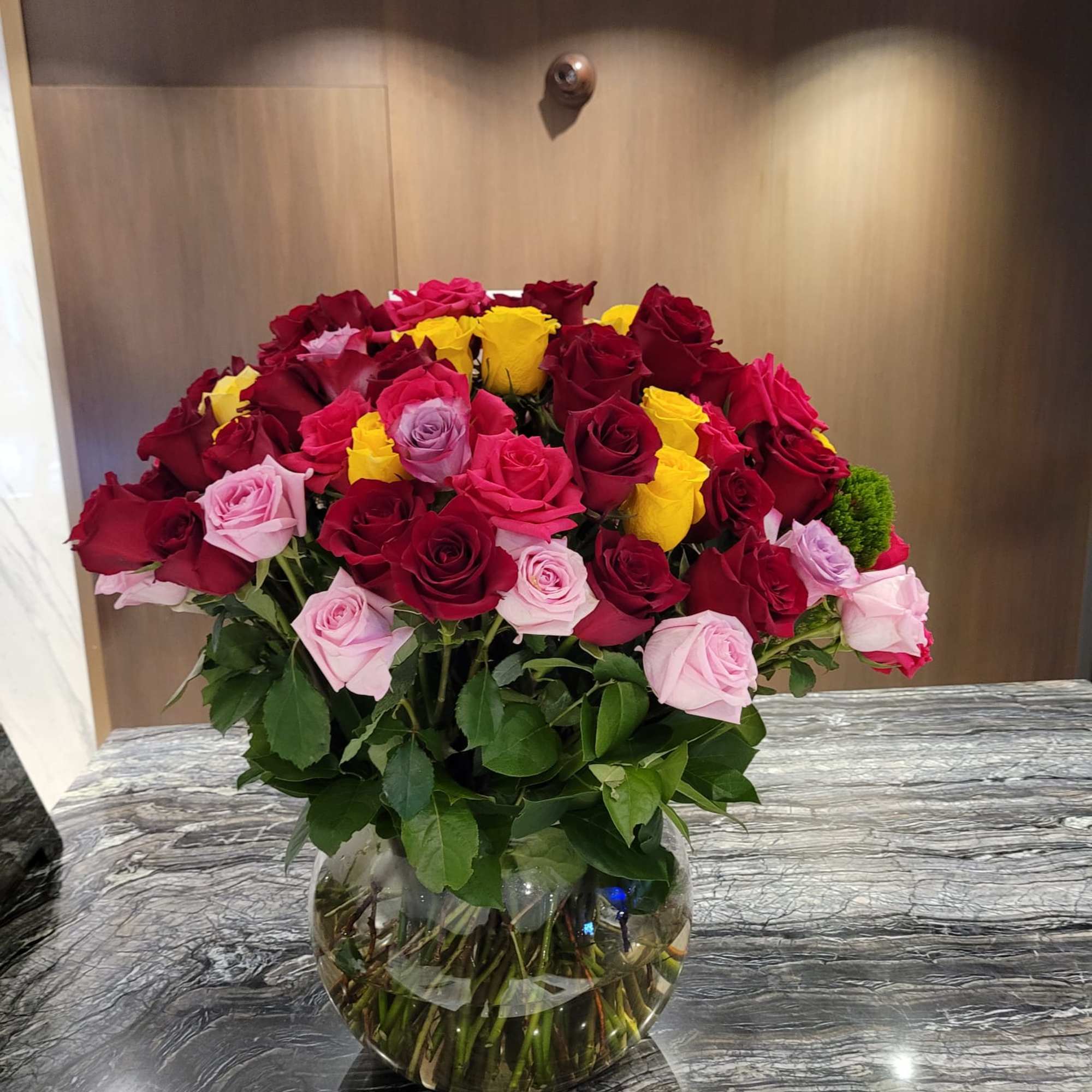 This is a beautiful arrangement in a clear glass vase with a This is a beautiful arrangement in a clear glass vase with a