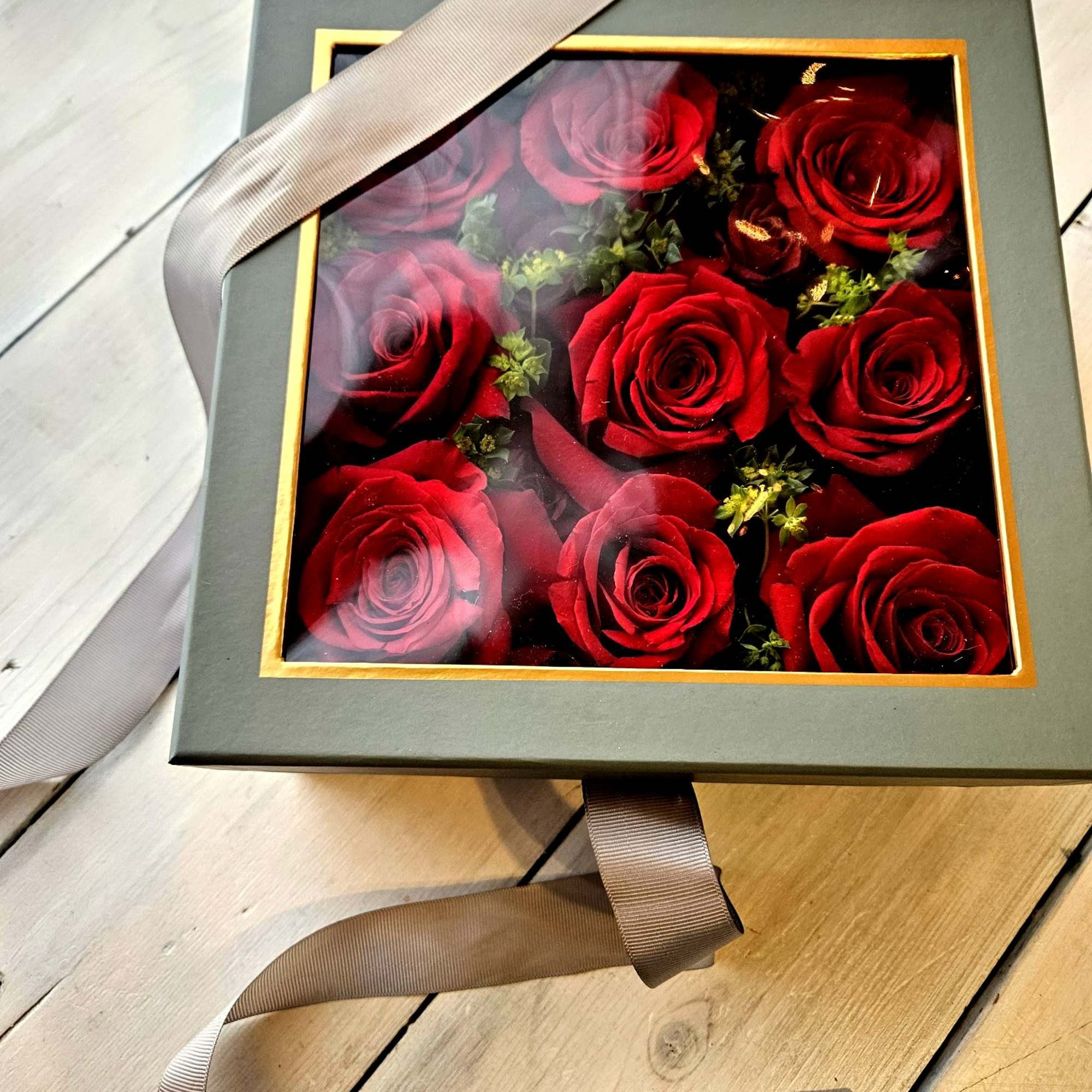 Low lush roses nestled beautifully in a soft gray peak-a-boo box. Its Low lush roses nestled beautifully in a soft gray peak-a-boo box. Its