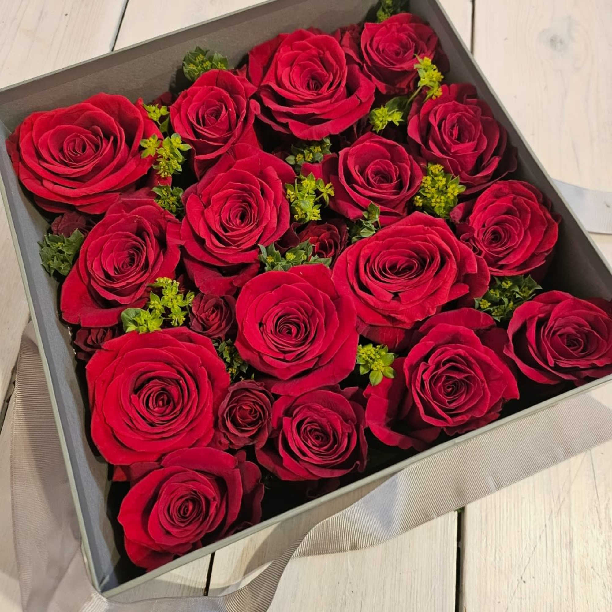 Low lush roses nestled beautifully in a soft gray peak-a-boo box. Its Low lush roses nestled beautifully in a soft gray peak-a-boo box. Its