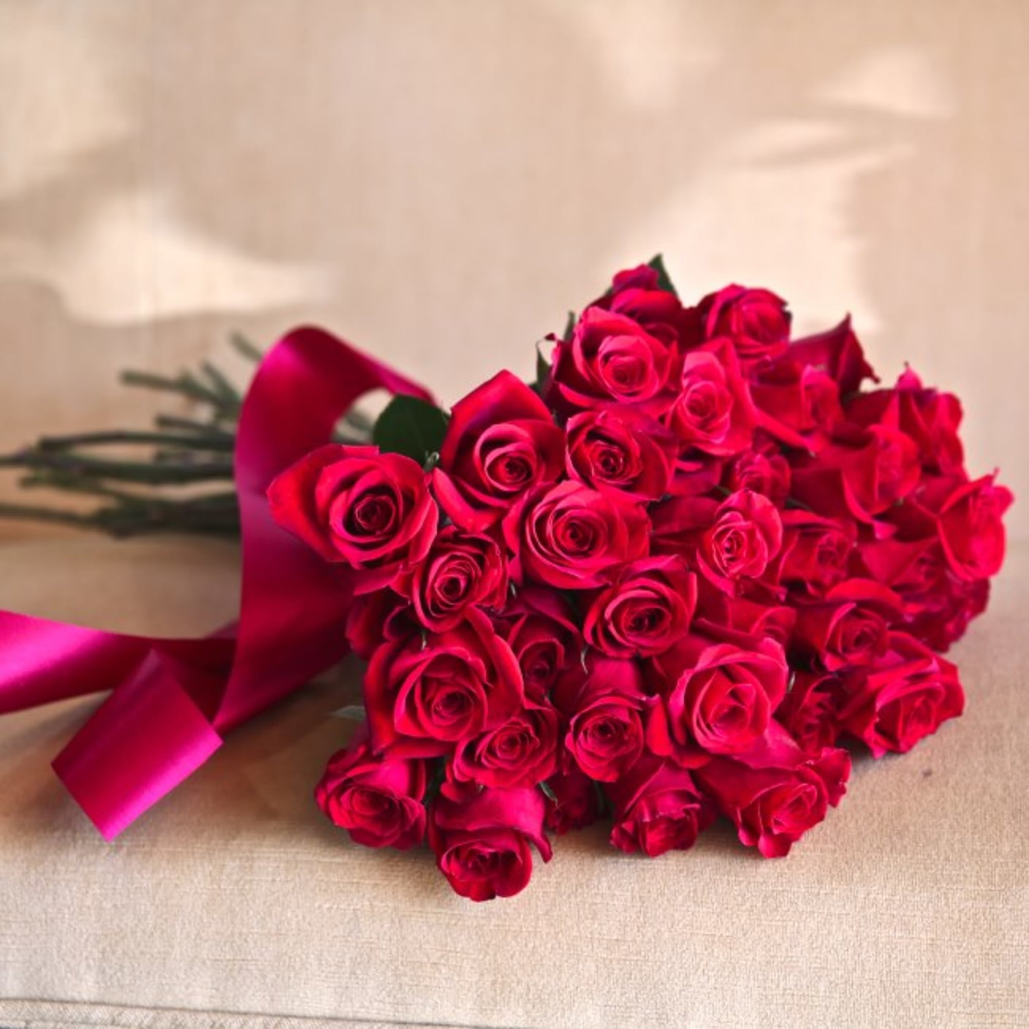 50 extra long stemmed red roses traditionally handtied with a red ribbon.