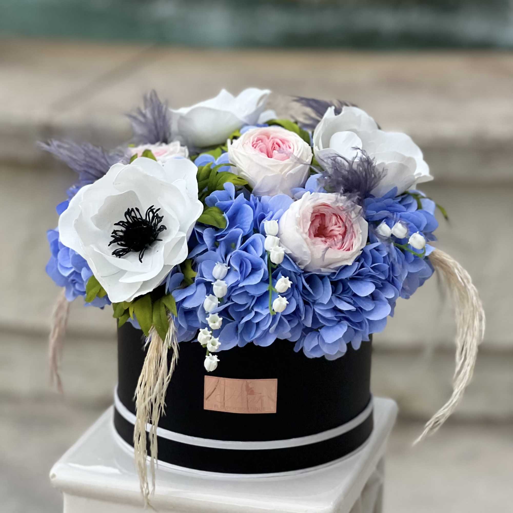 The Celestial Bloom Grande showcases a beautiful mix of blue hydrangeas, large