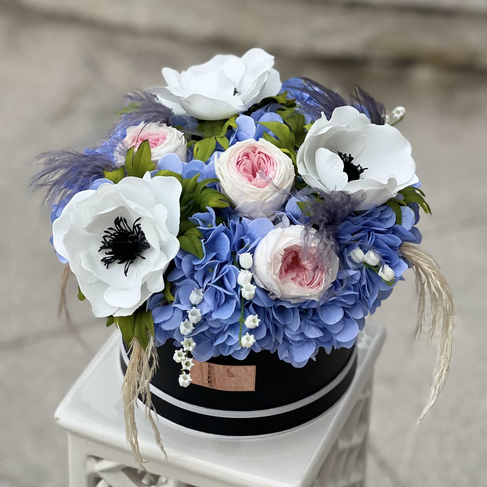 The Celestial Bloom Grande showcases a beautiful mix of blue hydrangeas, large
