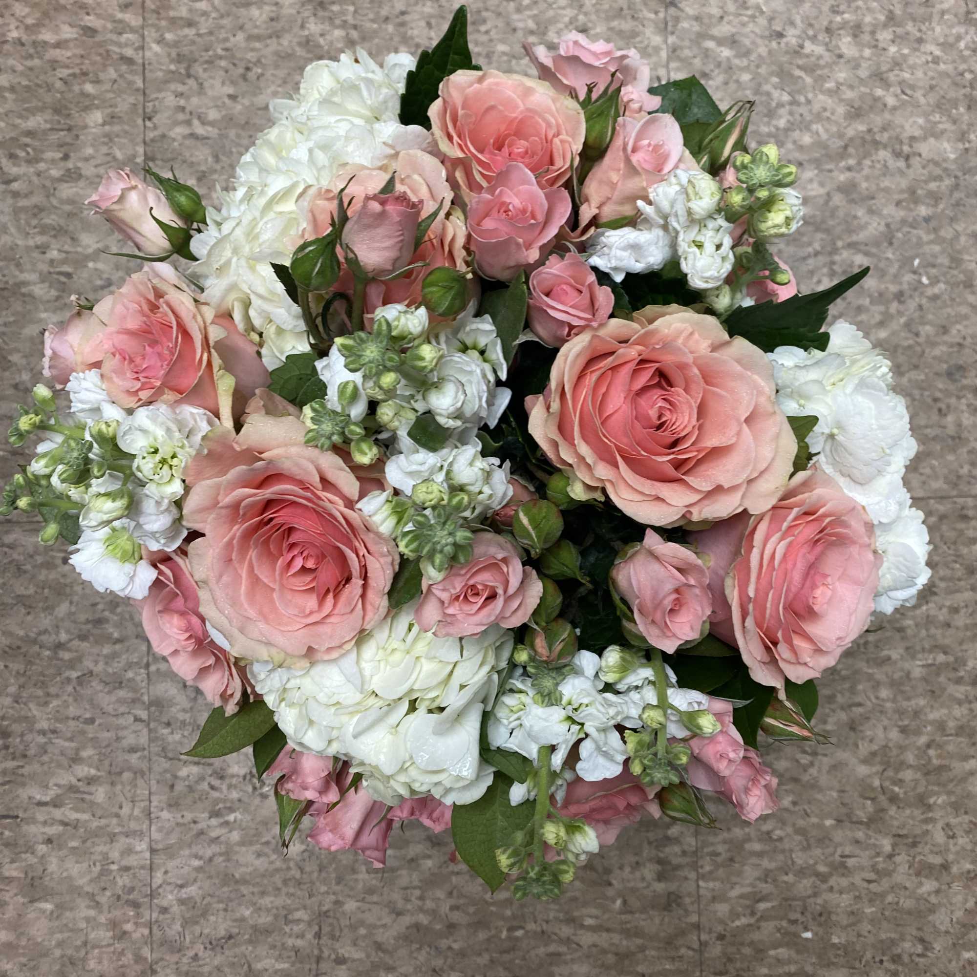 This angelic arrangement is as cute as it is pretty. Featuring the