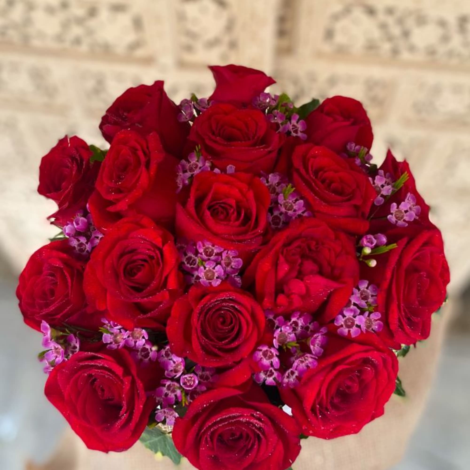 A dozen, big velvety roses in a round hat box. Finished off