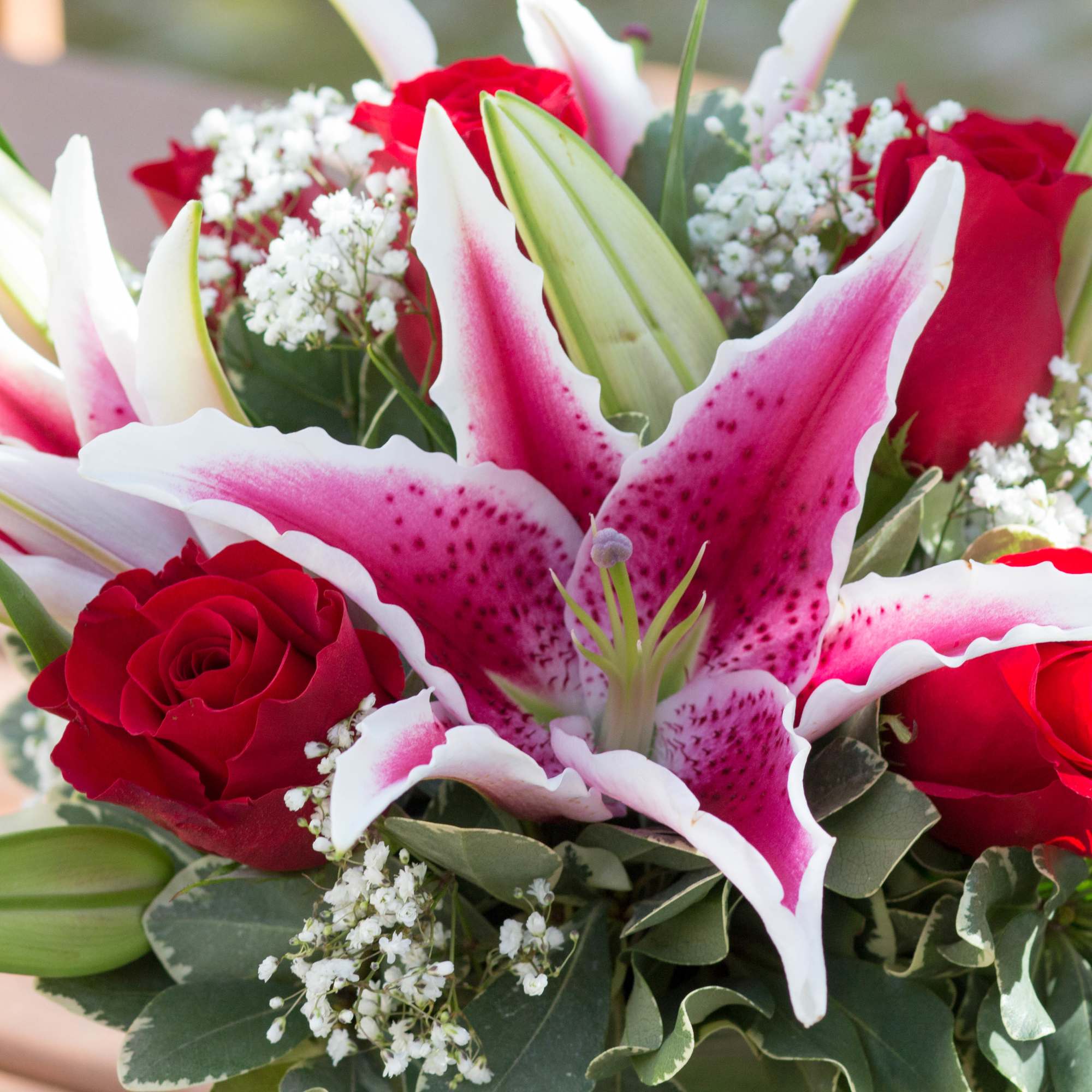 - 6 Freedom Roses
- 3 Pink Lilies
- Baby Breath
- Seasonal Greens - 6 Freedom Roses
- 3 Pink Lilies
- Baby Breath
- Seasonal Greens