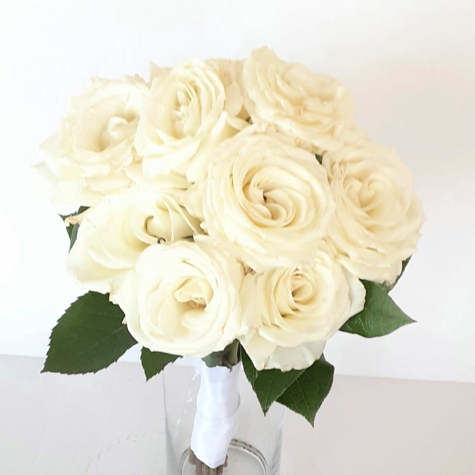 A classic rose and baby&#039;s breath bouquet hand tied with ribbon. The