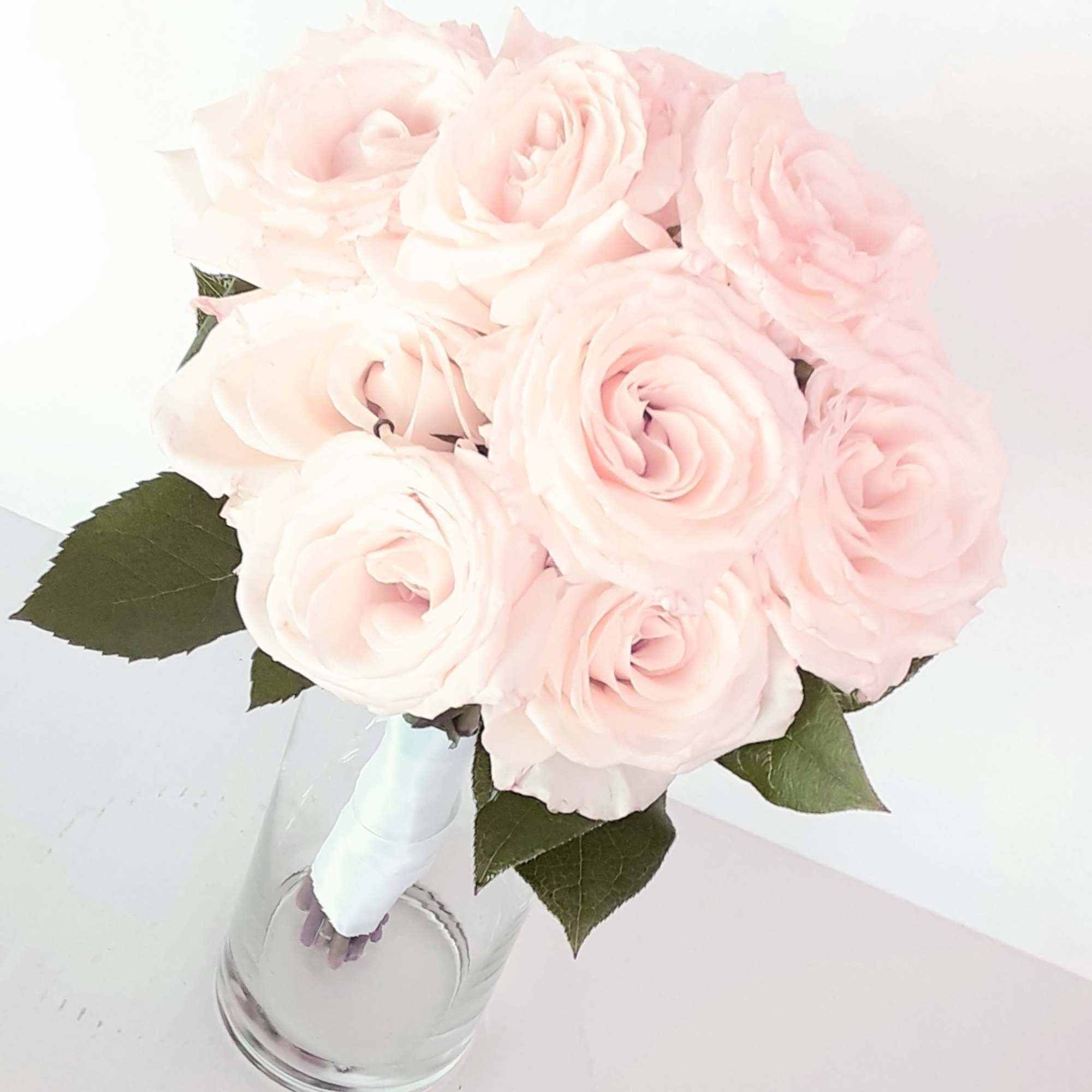 A classic rose and baby&#039;s breath bouquet hand tied with ribbon. The