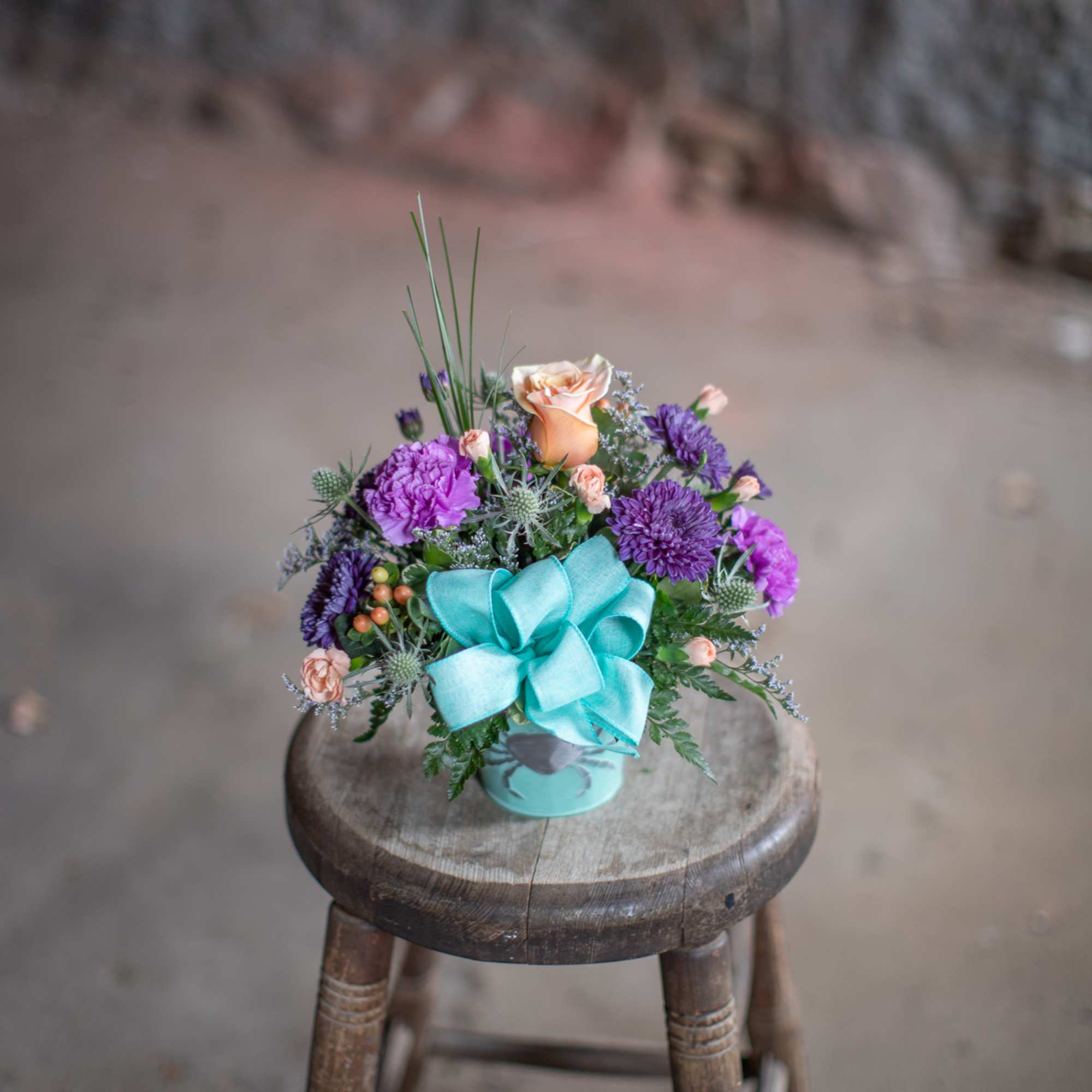 Cute, pail shaped tin containers in varying shades of blue to seafoam