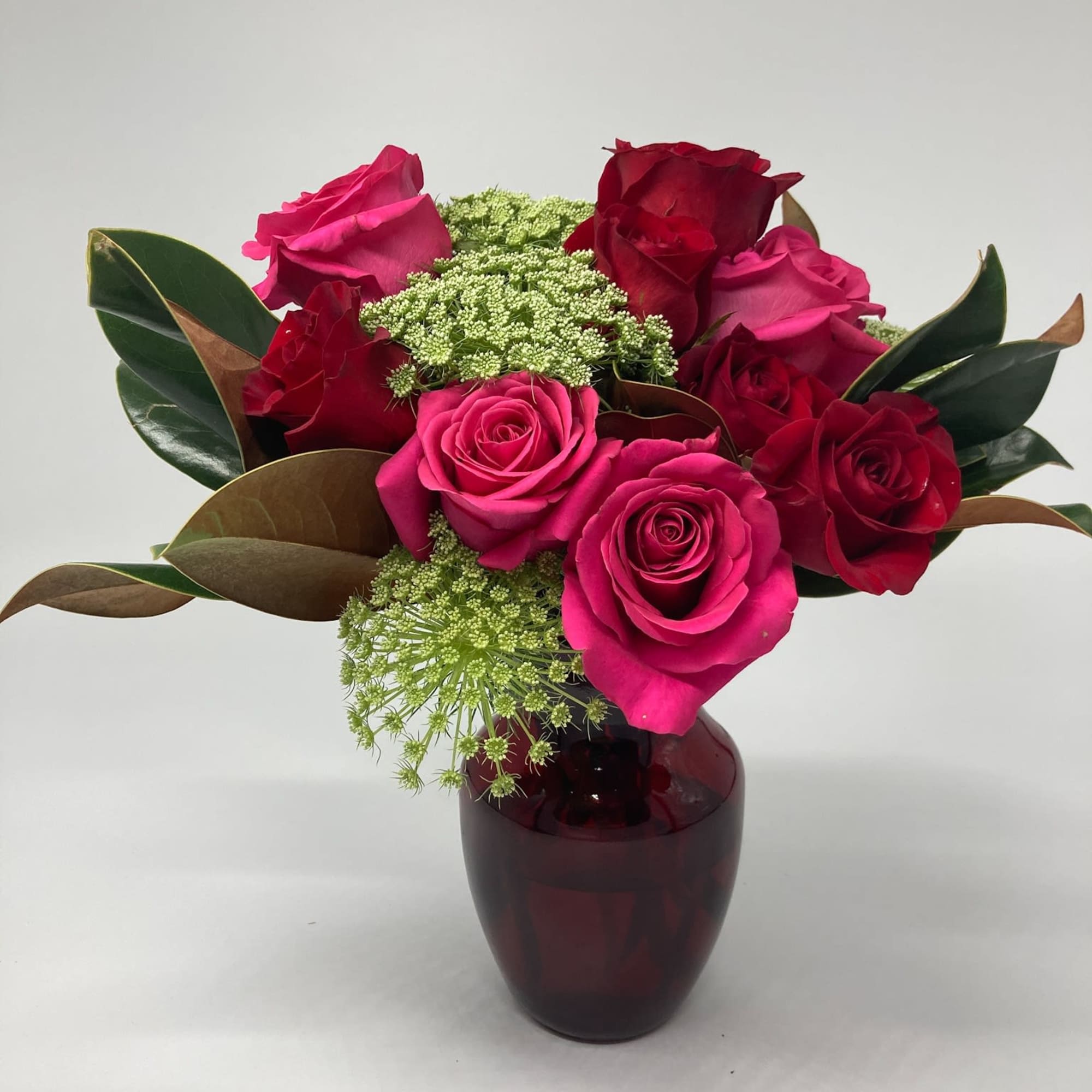 This lovely and traditional bouquet is featured a fluted red glass vase