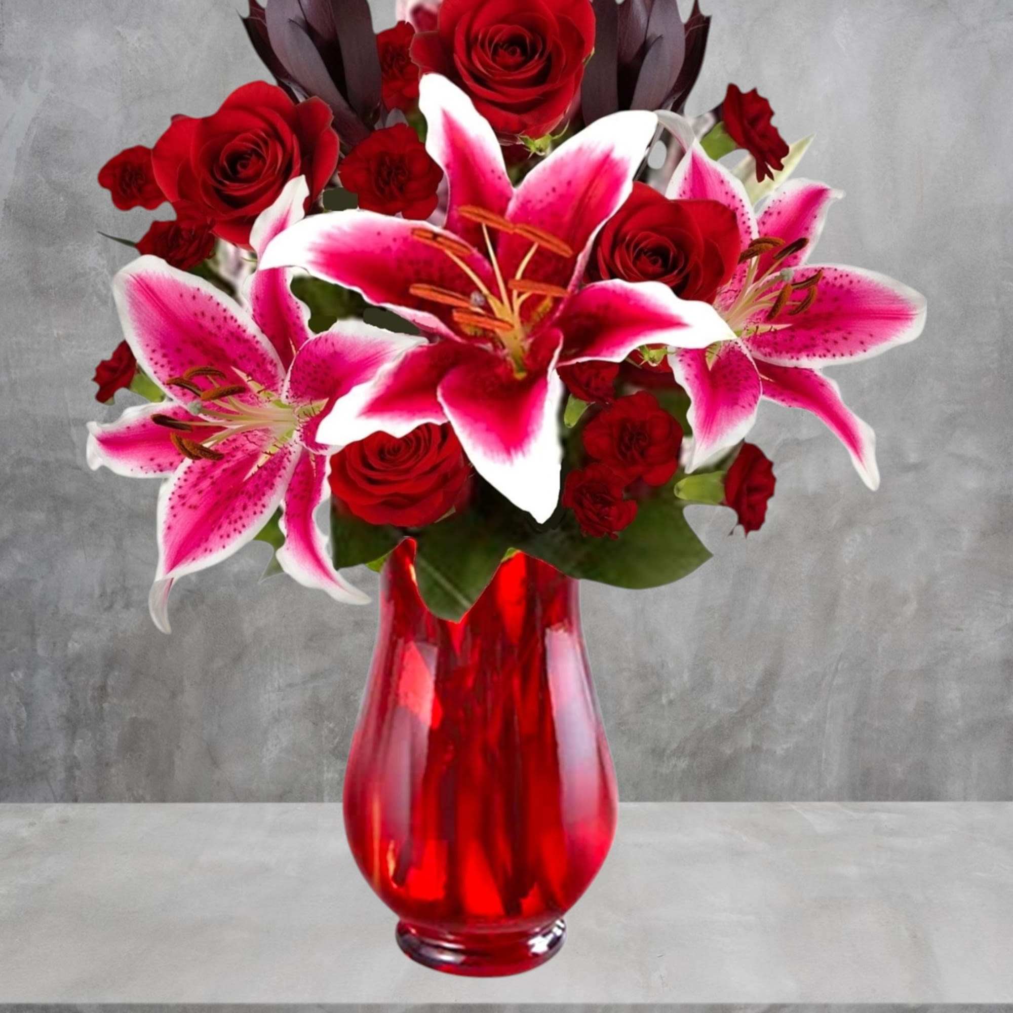Cupid&#039;s Floral Arrangement blossoms with roses and Stargazer lilies to display your