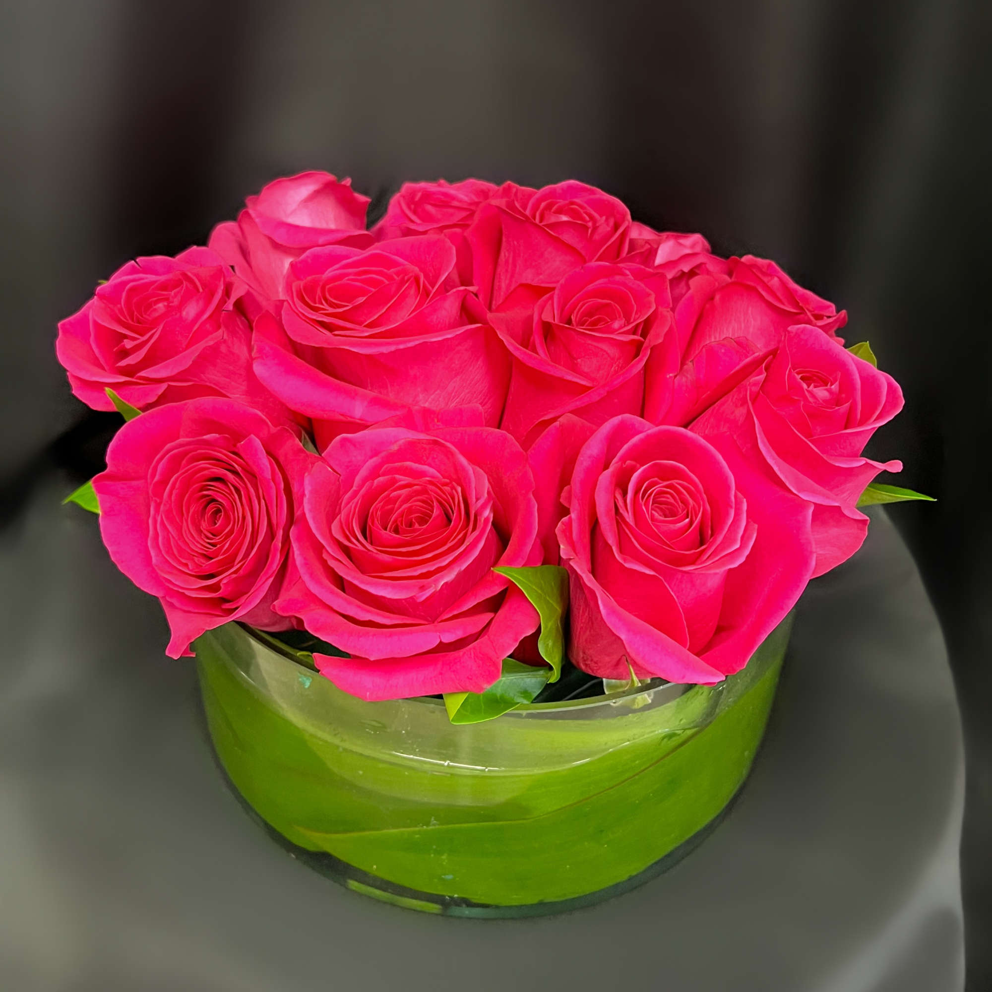 1 DZ ROSES IN A CLEAR VASE WITH A TEA LEAF INSIDE