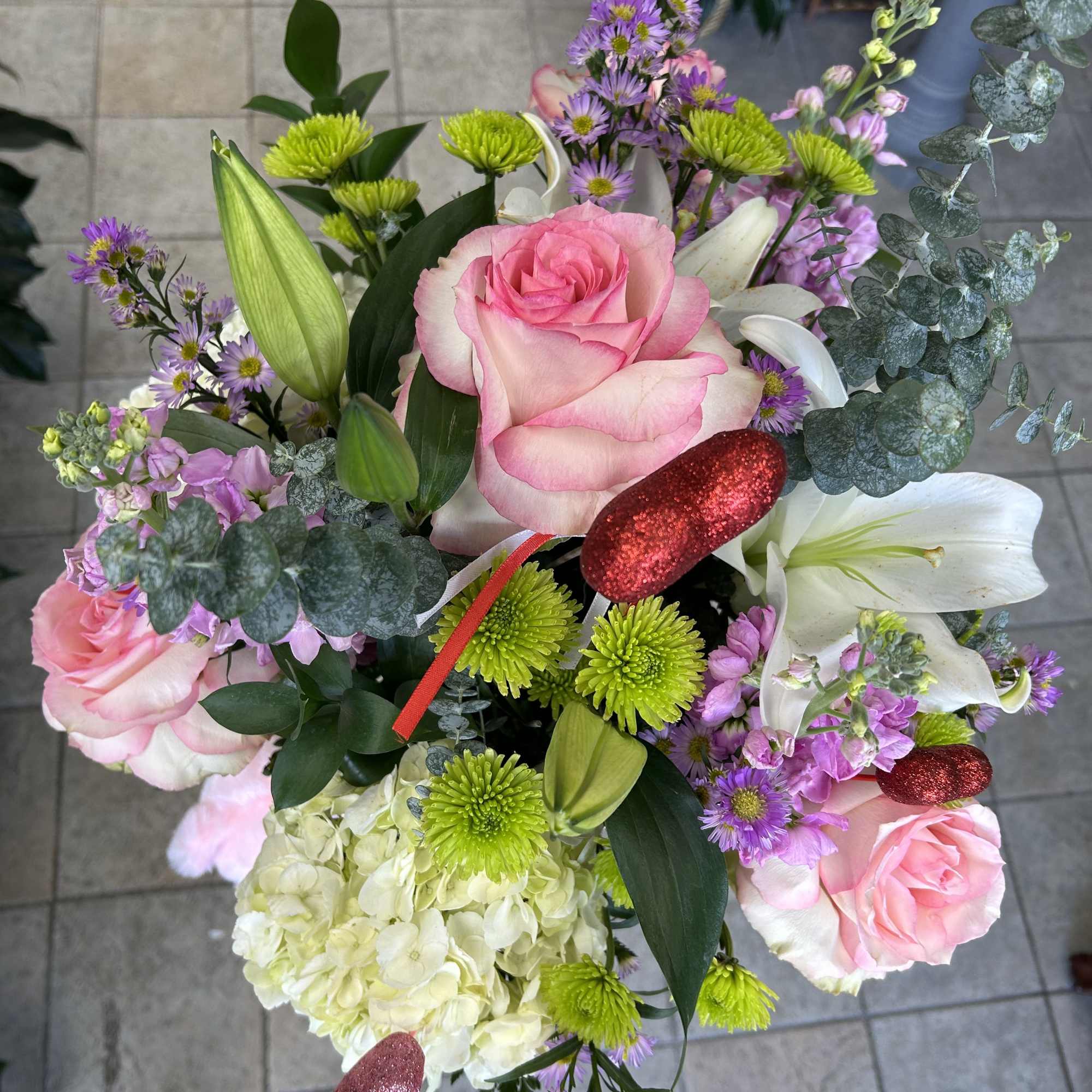 Makea day special with a beautiful flower arrangement and a soft teddy