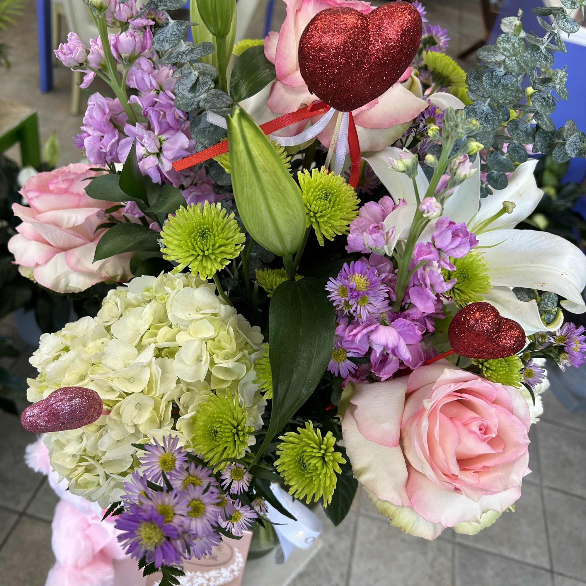 Makea day special with a beautiful flower arrangement and a soft teddy