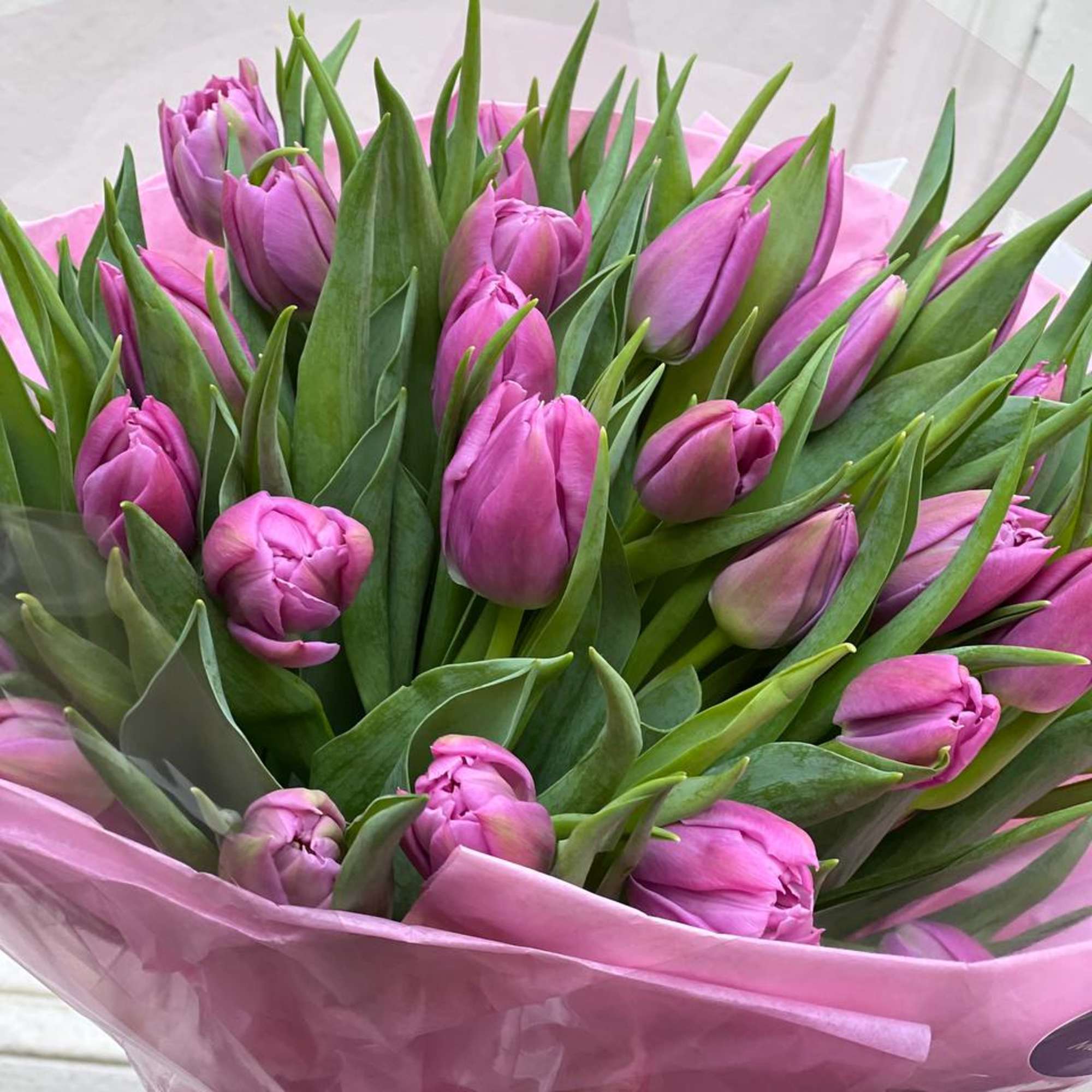 A mono bouquet of purple tulips is a bright and stylish composition