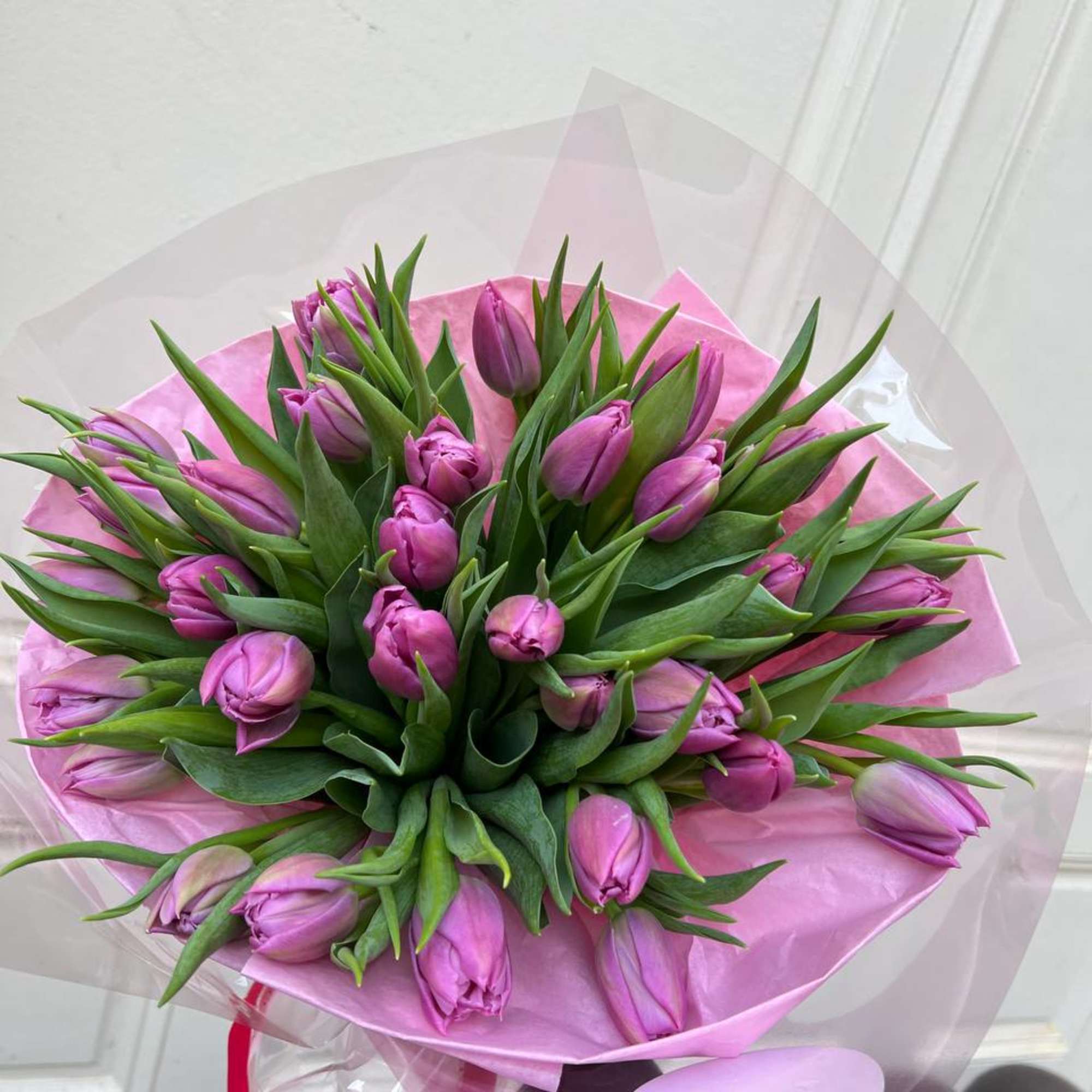 A mono bouquet of purple tulips is a bright and stylish composition