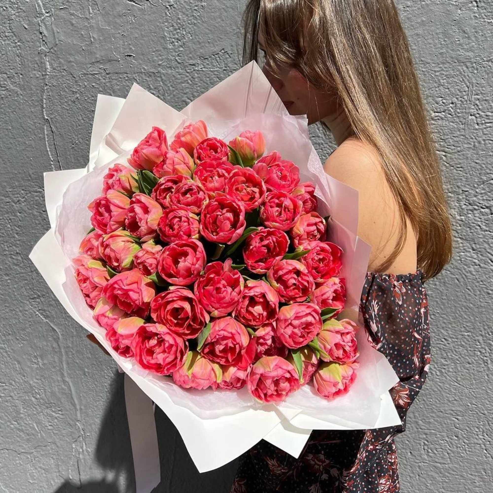 A bouquet of bright pink tulips is a lively and energetic composition