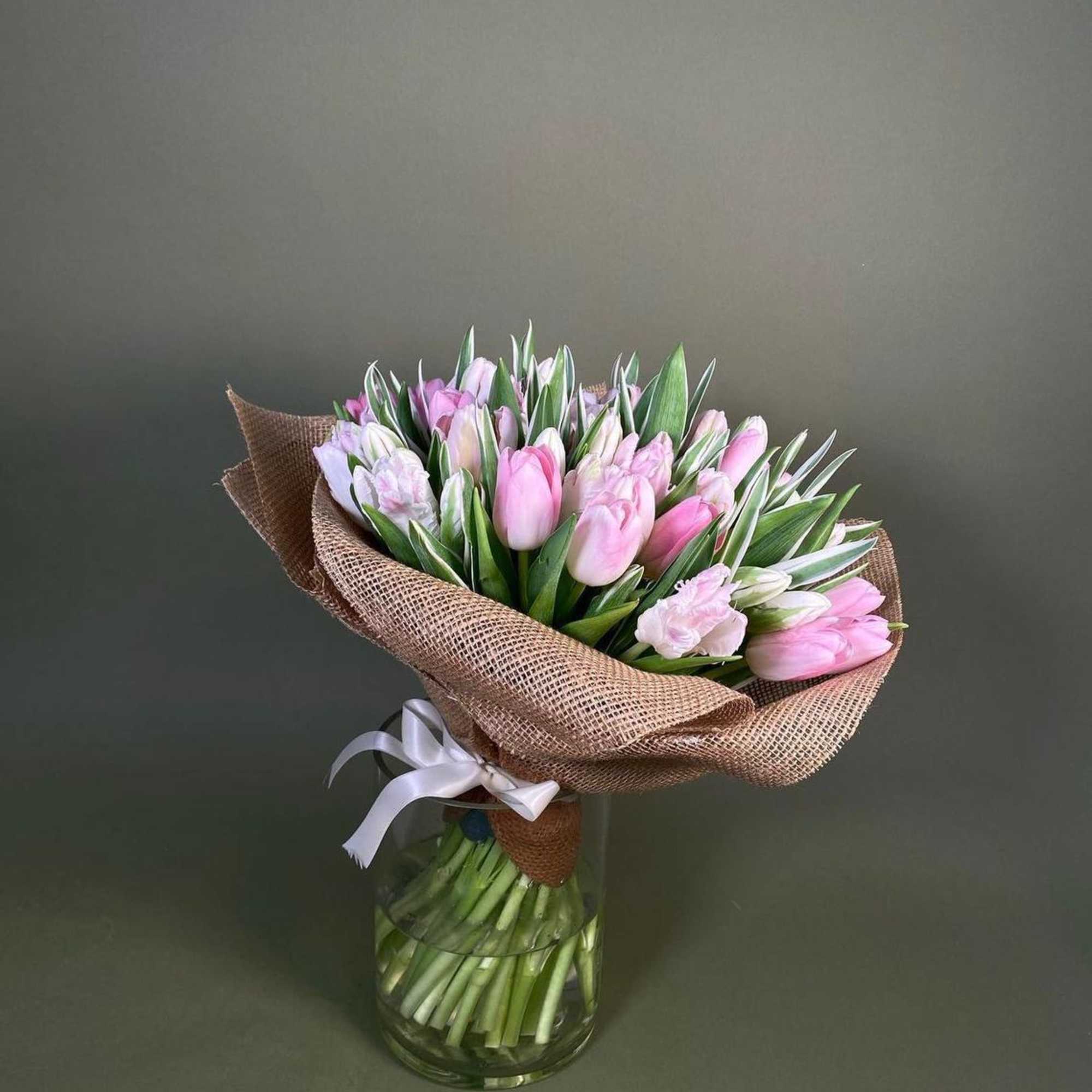 A bouquet of pink tulips is a delicate and bright composition that