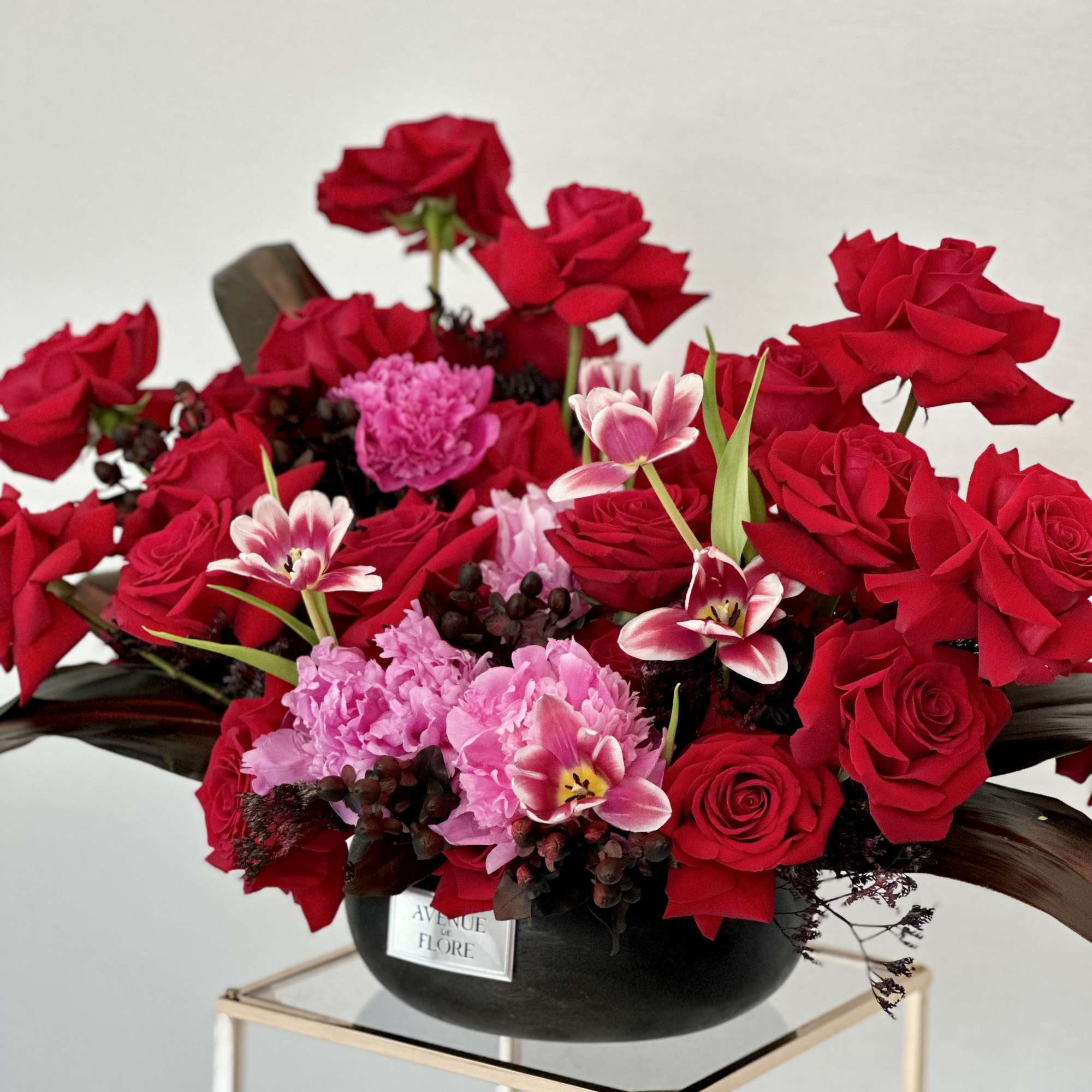 A breathtaking arrangement that harmonizes the timeless elegance of red roses with