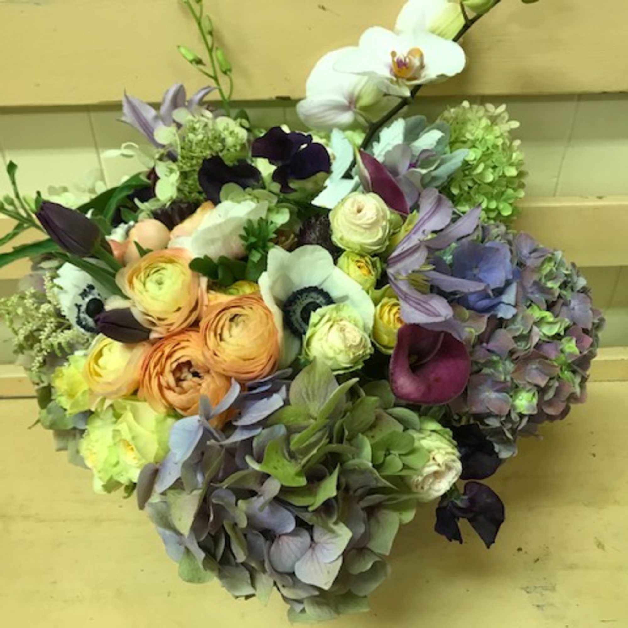 Stylish medley in purple, peach, white and green hues, presented in a