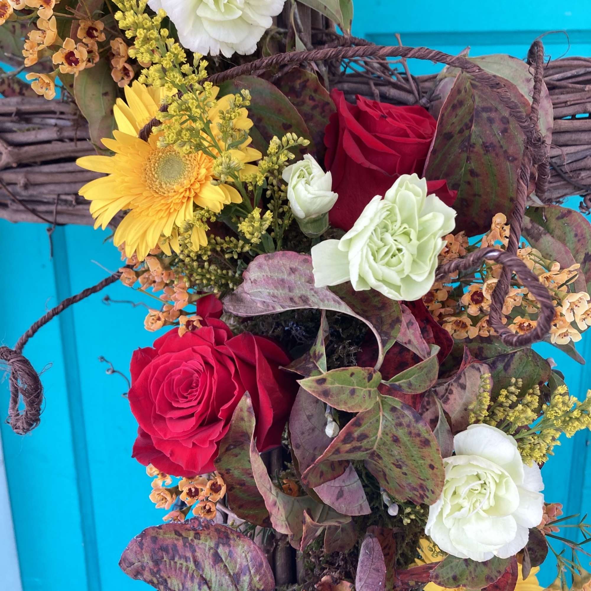 A beautiful standing spray using a grapevine cross as the base and