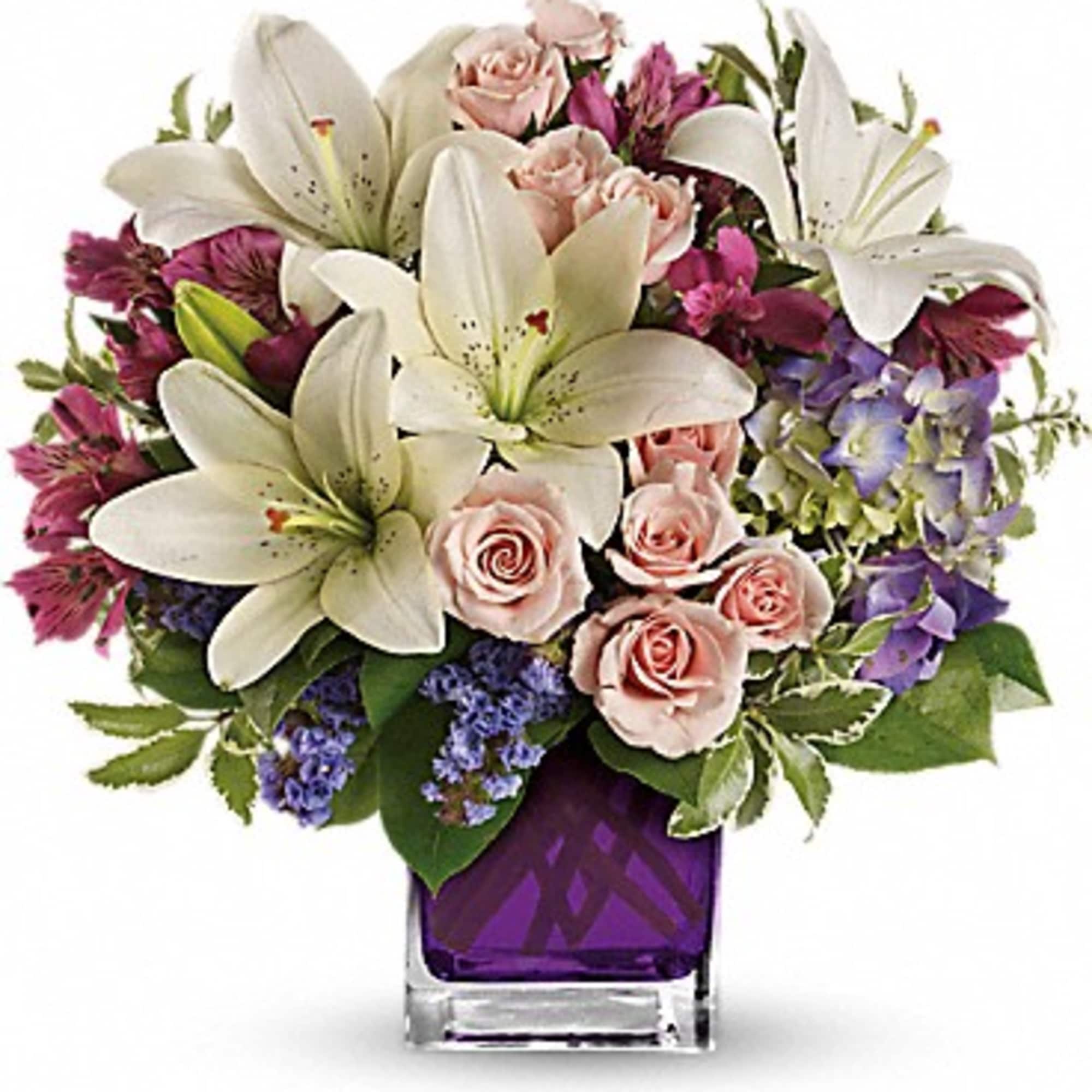 A mix of fresh flowers such as spray roses, daisy and button