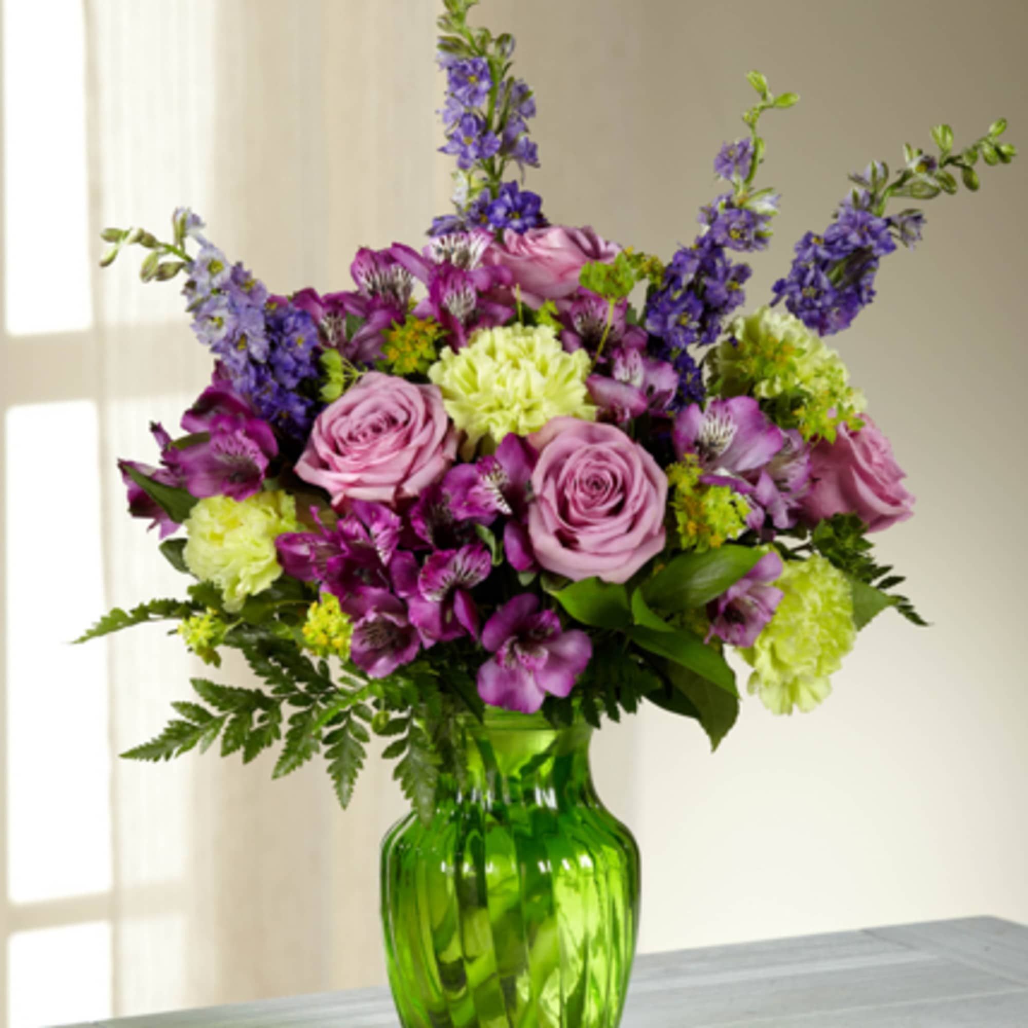 Captivate your recipient with the graceful beauty of this arrangement featuring lavender