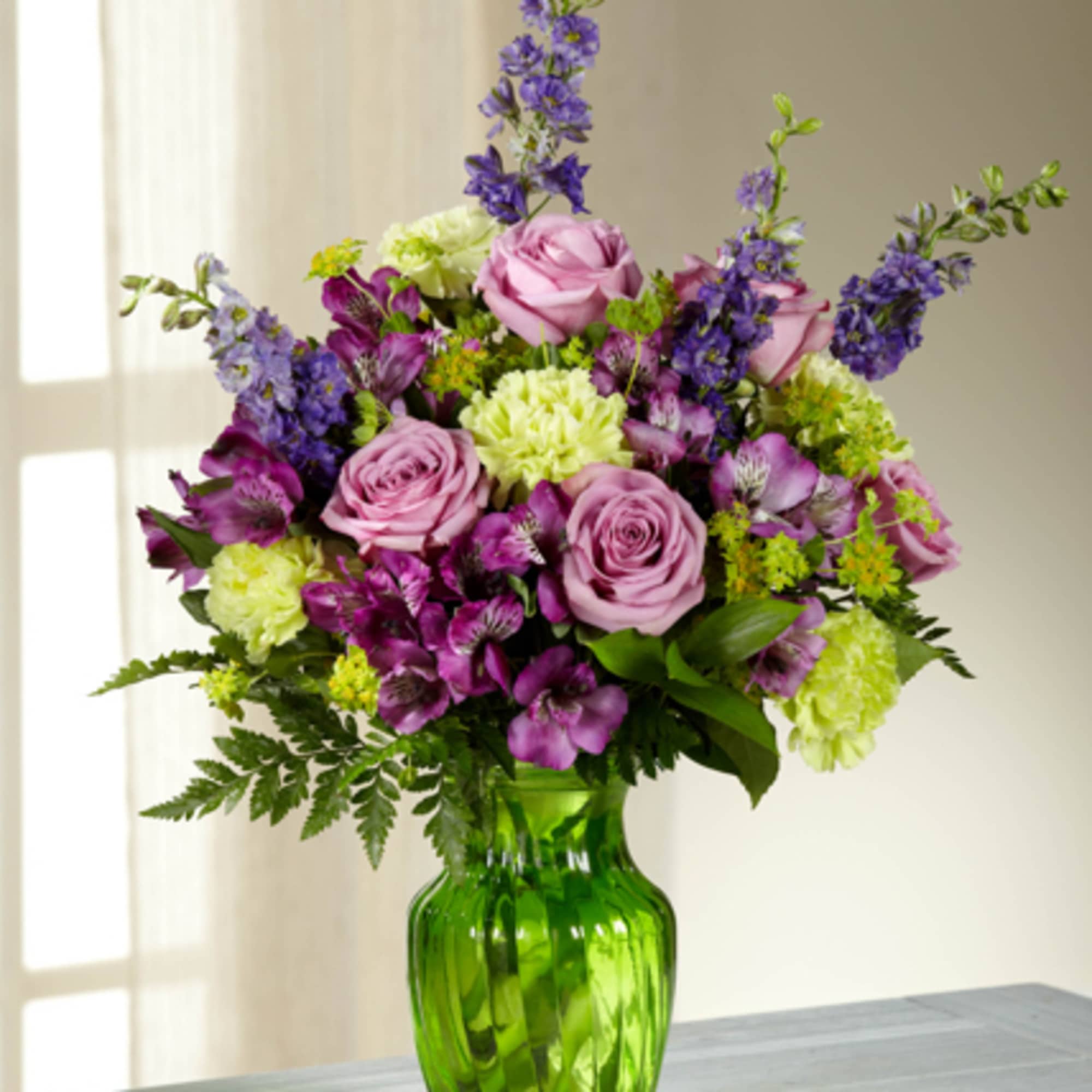 Captivate your recipient with the graceful beauty of this arrangement featuring lavender