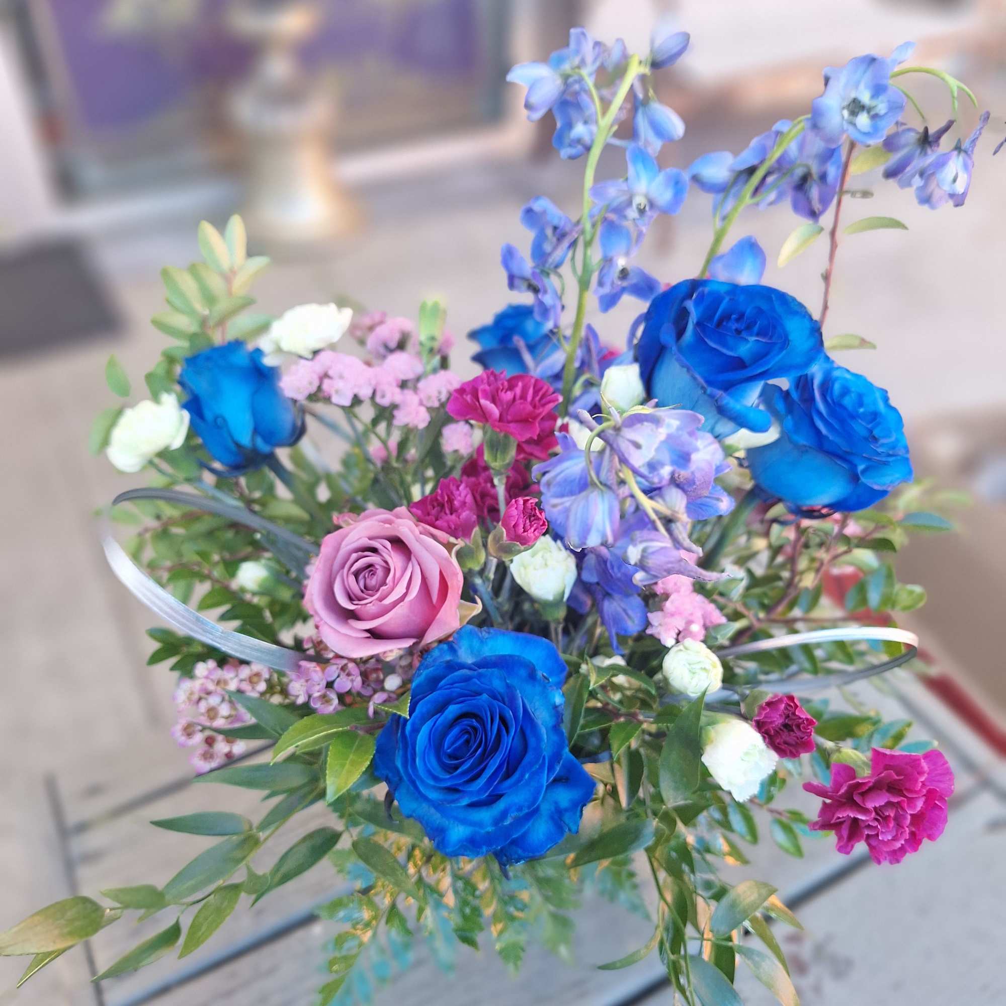 A blend of Blue, Lavender and Fuschia with green filler and greenery A blend of Blue, Lavender and Fuschia with green filler and greenery