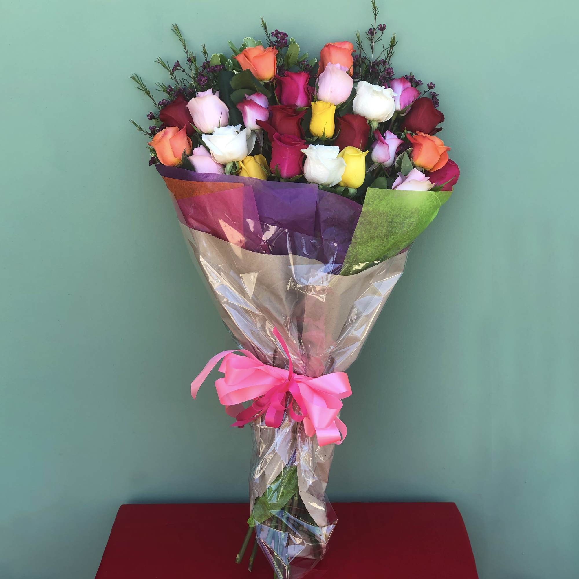 This Arrangement includes 4 dozen long stem Mixed Color Roses wrapped with This Arrangement includes 4 dozen long stem Mixed Color Roses wrapped with