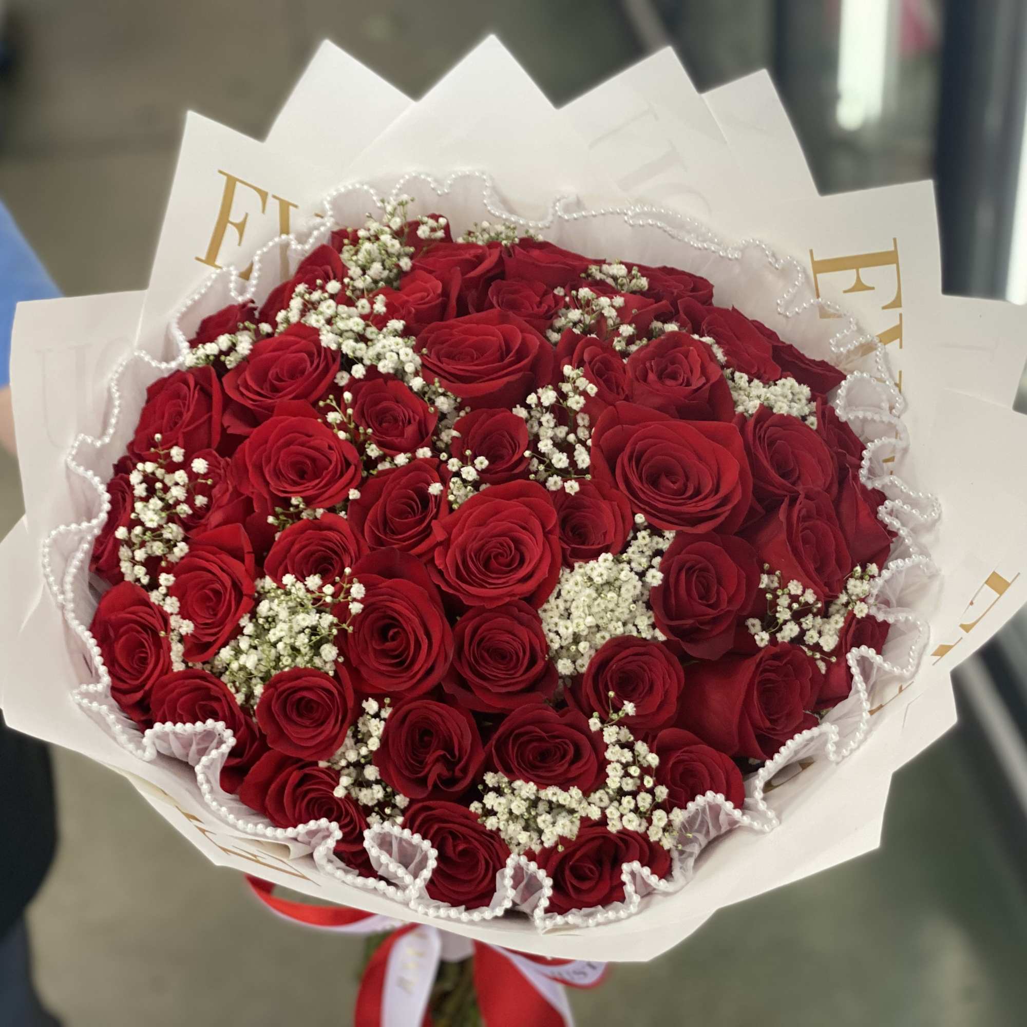 Photo is 48 Roses, Babies breath, Pearl Wrapping. All included. 
You may