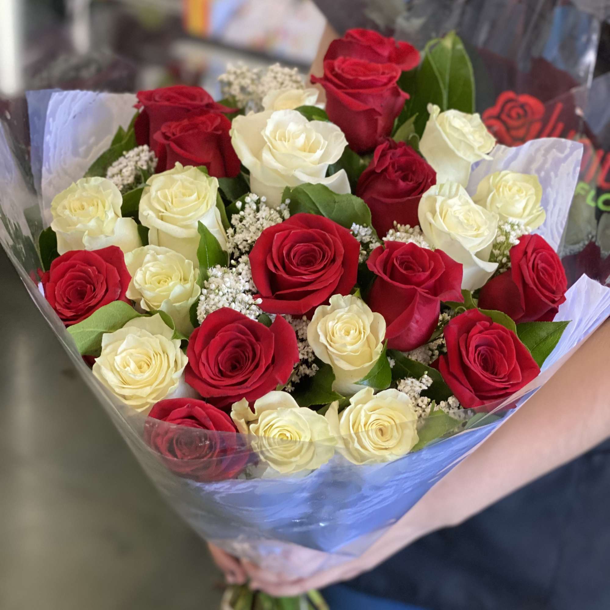 Wrapped in cellophane/plastic paper and a simple colored Polyester paper. These are