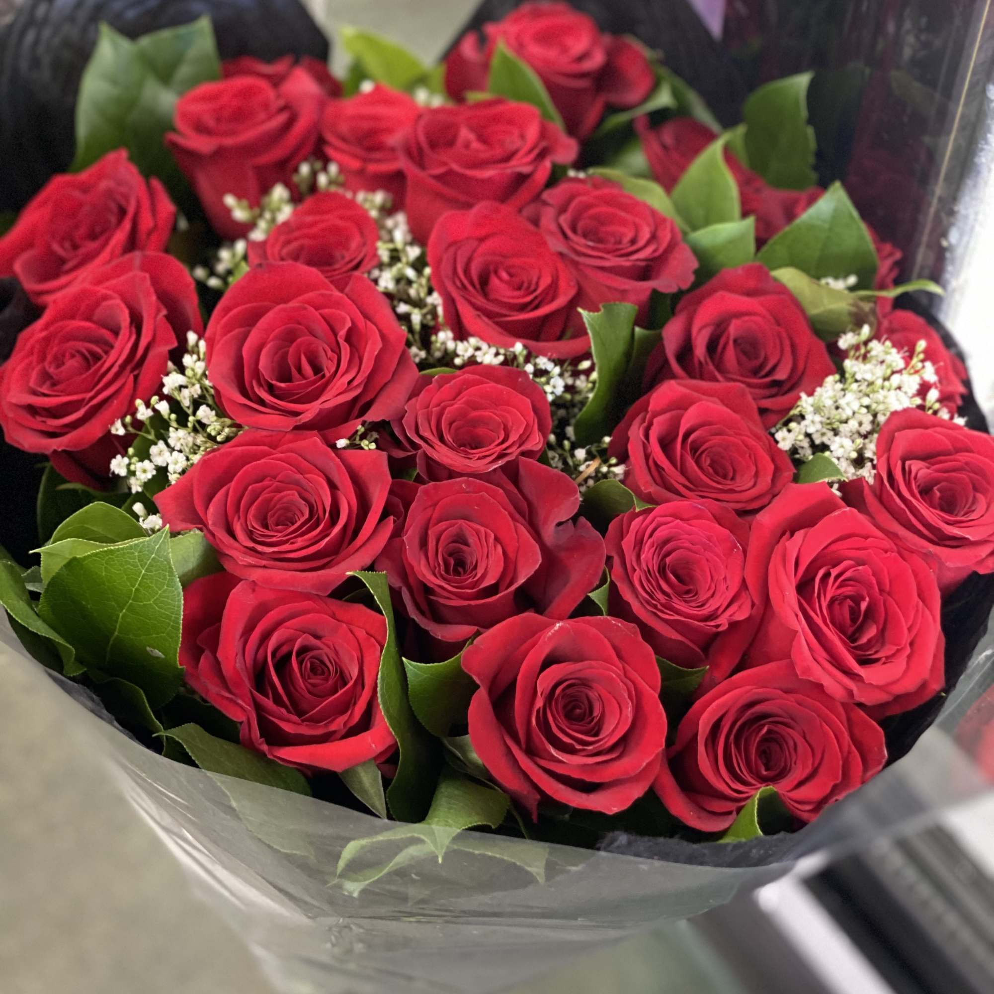 Wrapped in cellophane/plastic paper and a simple colored Polyester paper. These are