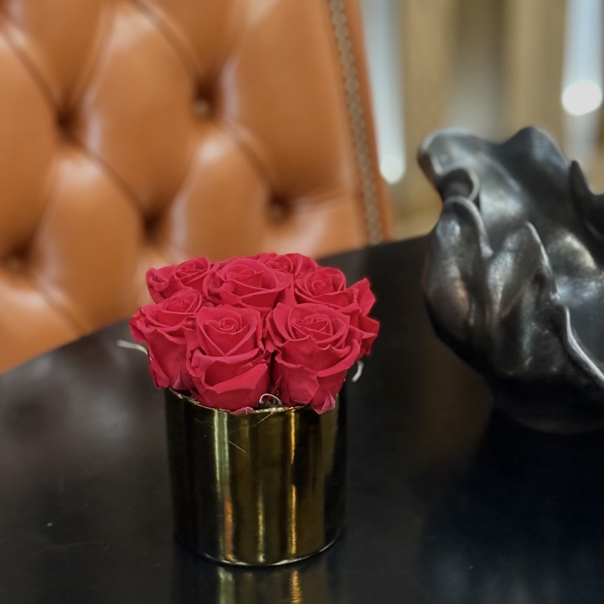 This sleek, modern gold vase holds a stunning arrangement of preserved red
