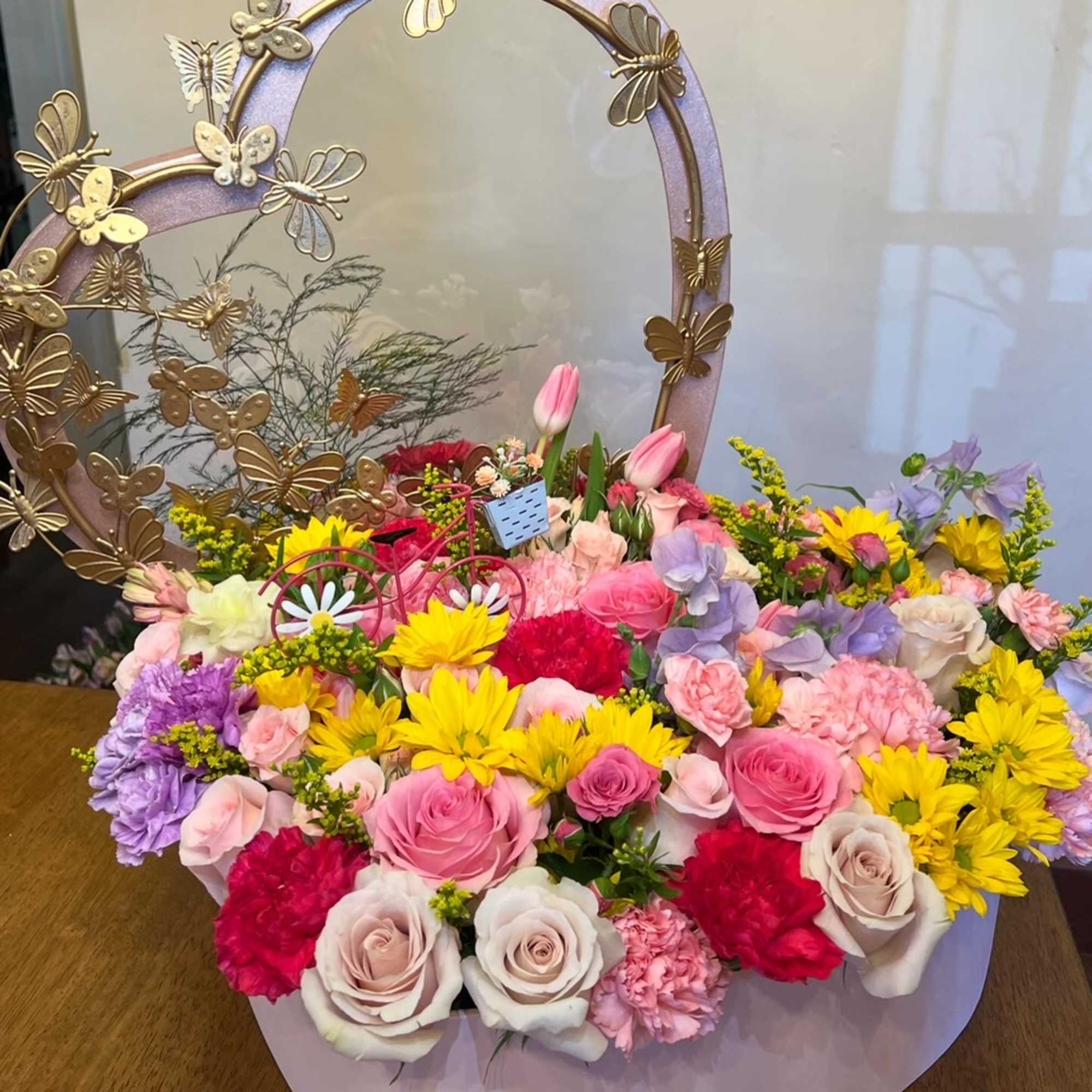 Large heart box with metal butterfly frame. 
Spring flowers: roses, carnation, alstromerias