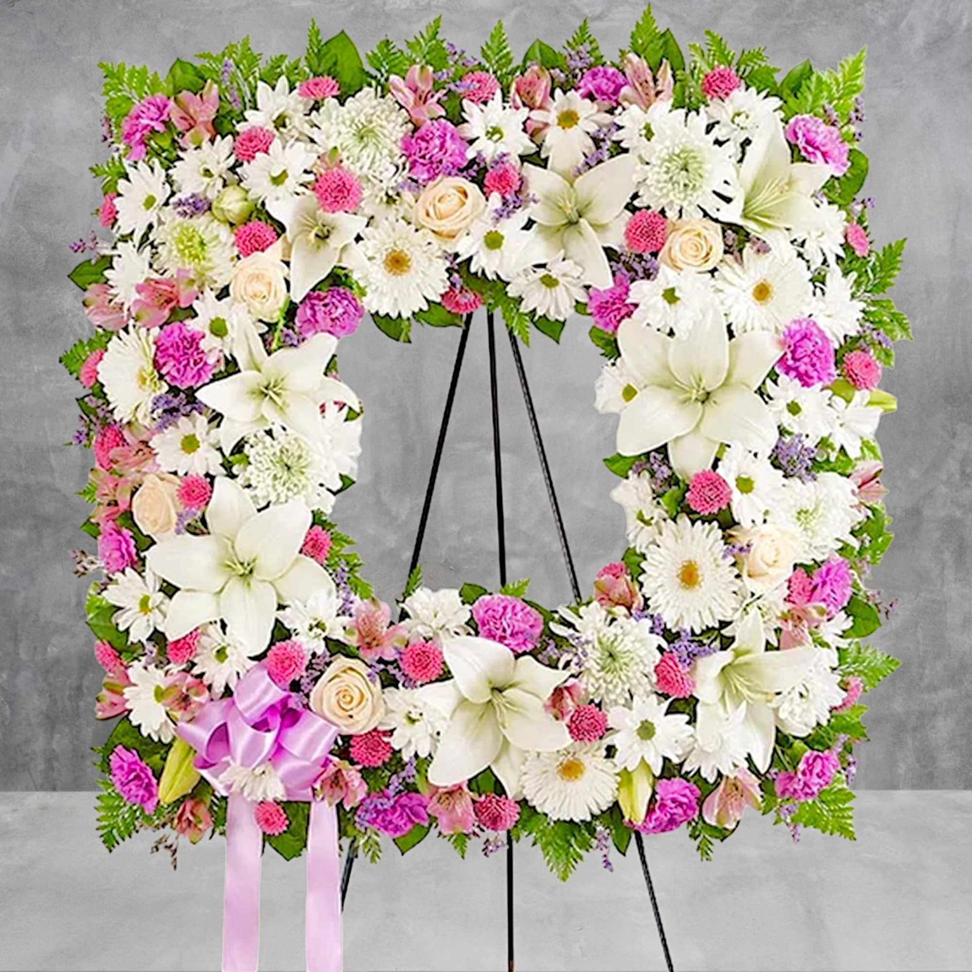 Offer solace with a sentimental arrangement for the services. The square wreath