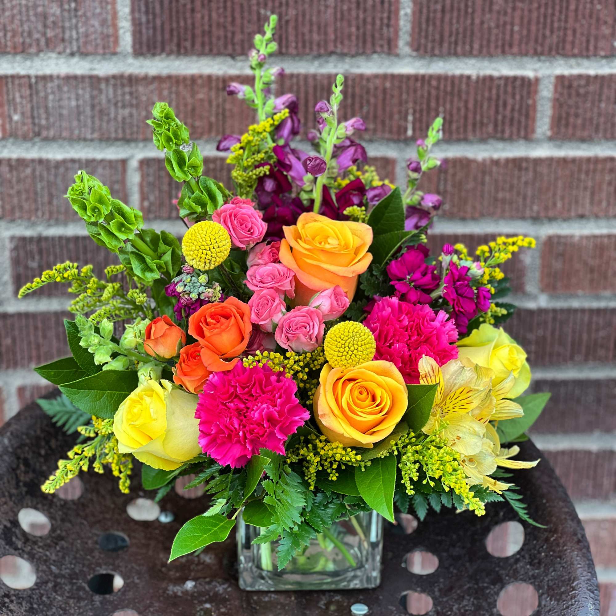 In a cube vase and full of bold and vibrant yellows, hot In a cube vase and full of bold and vibrant yellows, hot