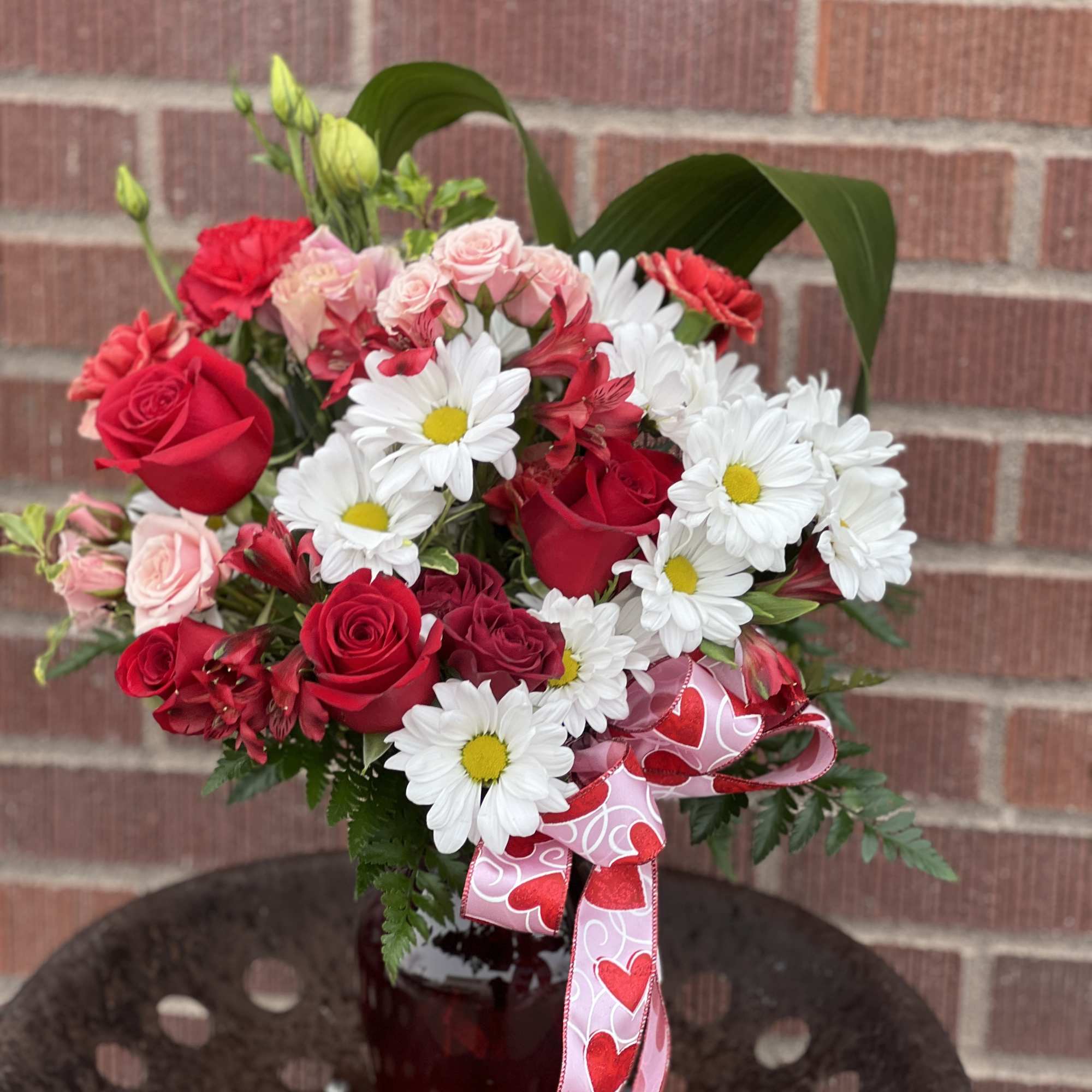 Designed by one of our local gals, this piece features red roses Designed by one of our local gals, this piece features red roses