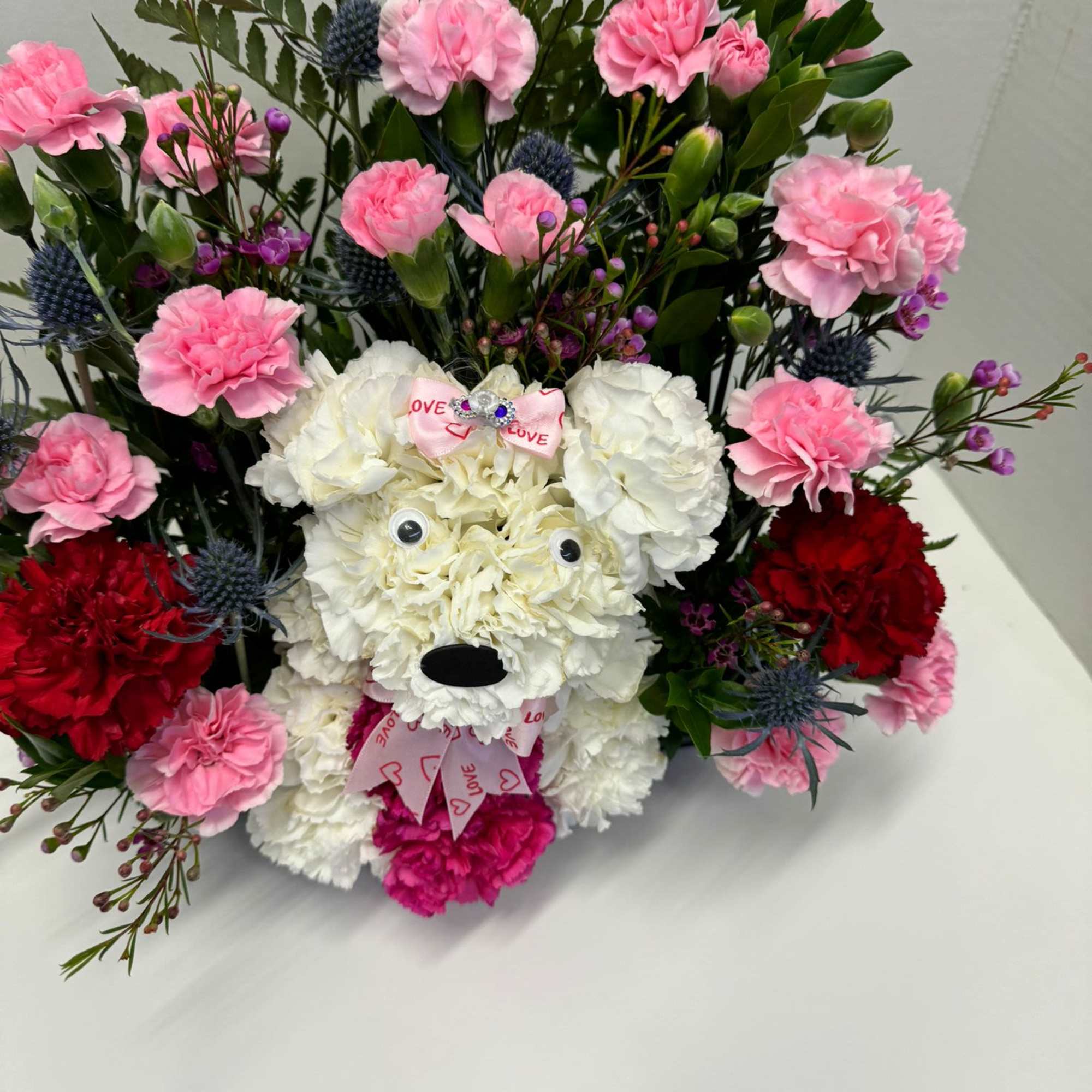  Talk about puppy love! Crafted from lasting white carnations, our canine