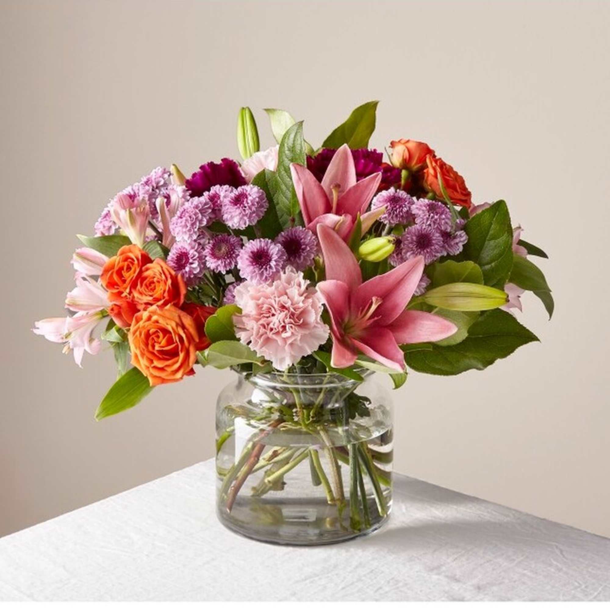 This vibrant bouquet features roses, lilies, carnations & more flowers to show This vibrant bouquet features roses, lilies, carnations & more flowers to show